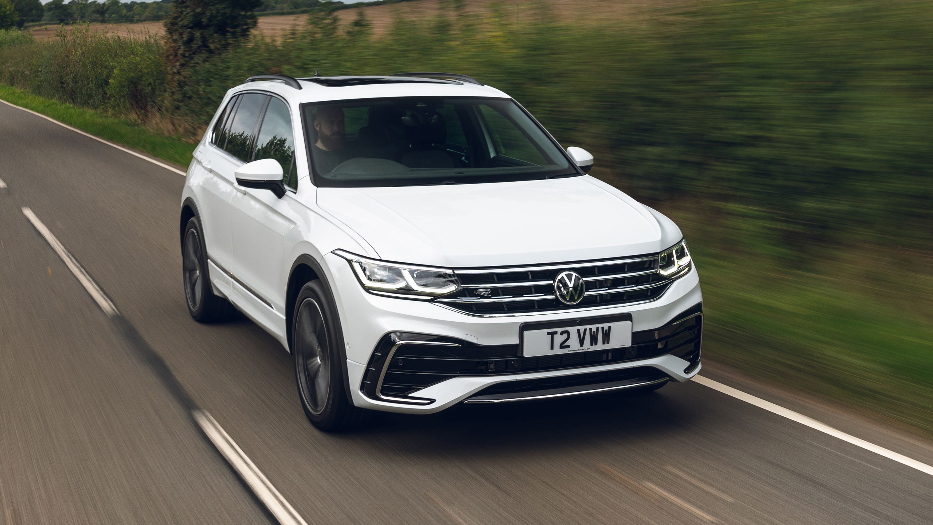 White Volkswagen Tiguan front driving