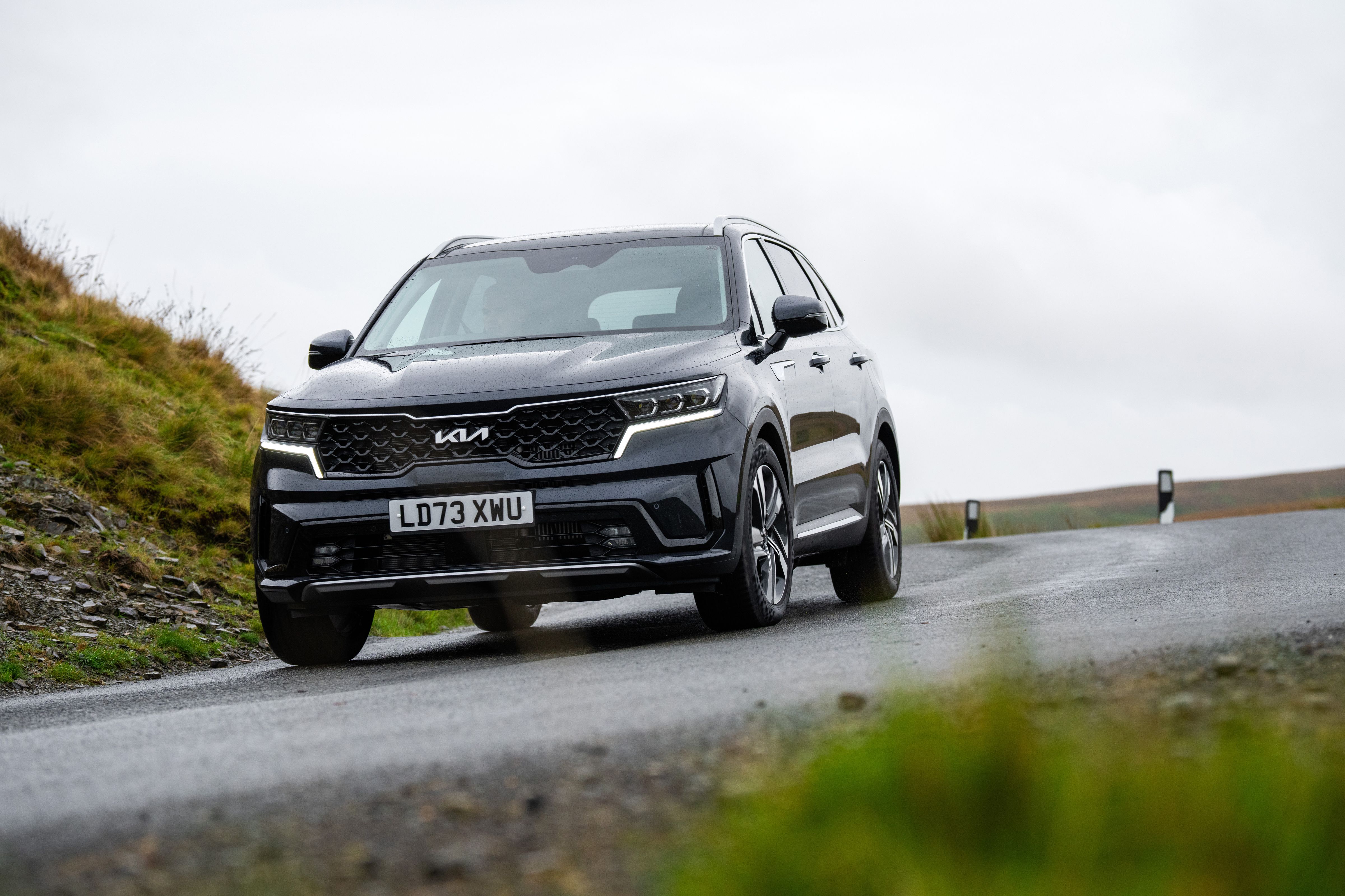 Grey Kia Sorento driving