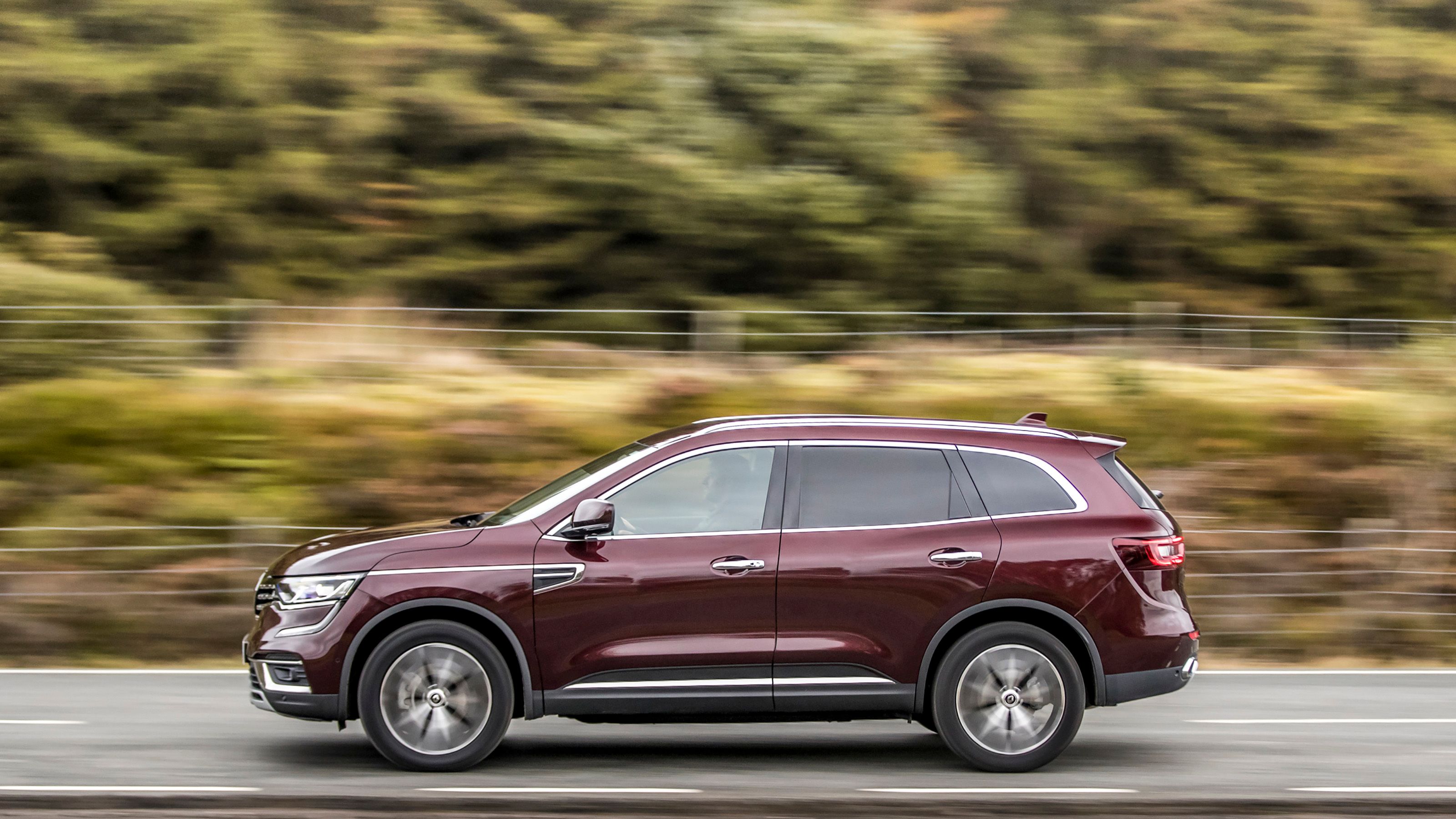 Maroon Renault Koleos side driving