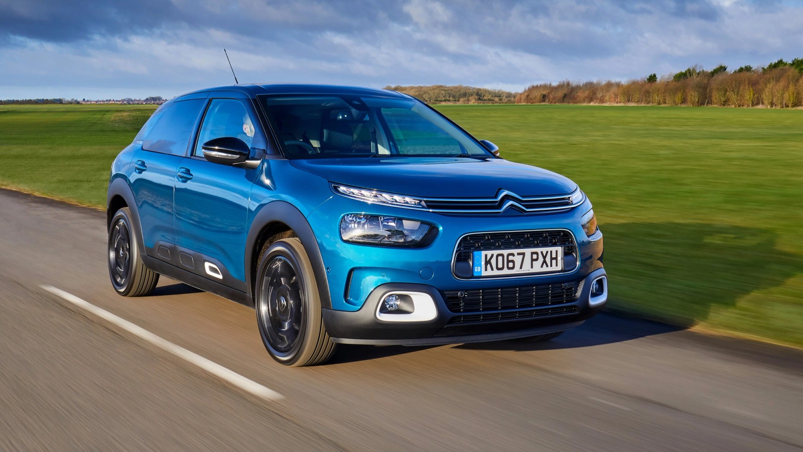 Blue Citroen C4 front driving
