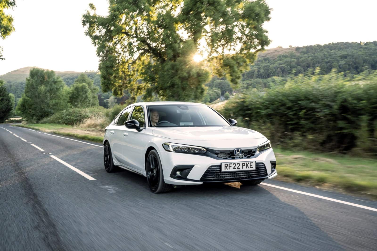 White Honda Civic driving