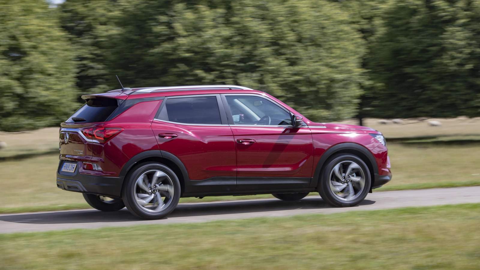 Red SsangYong Korando rear driving