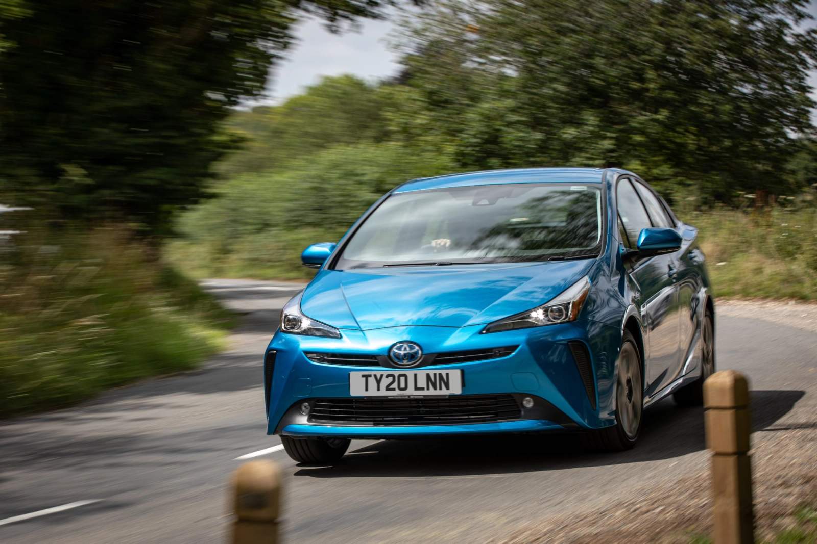 Blue Toyota Prius driving
