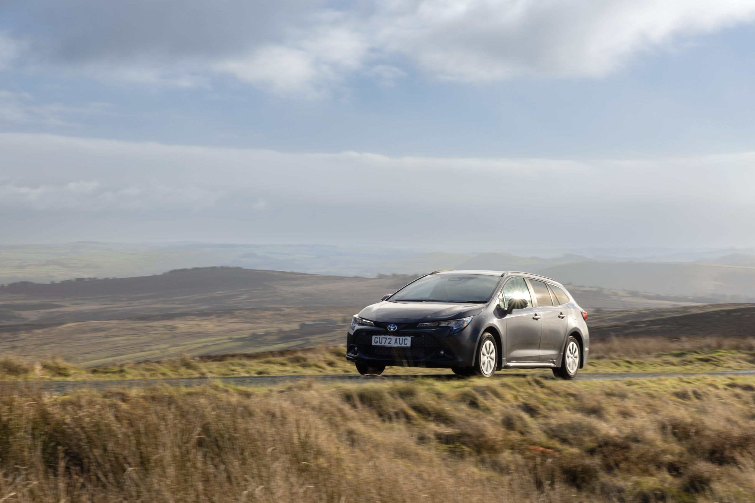 Grey Toyota Corolla Commercial driving