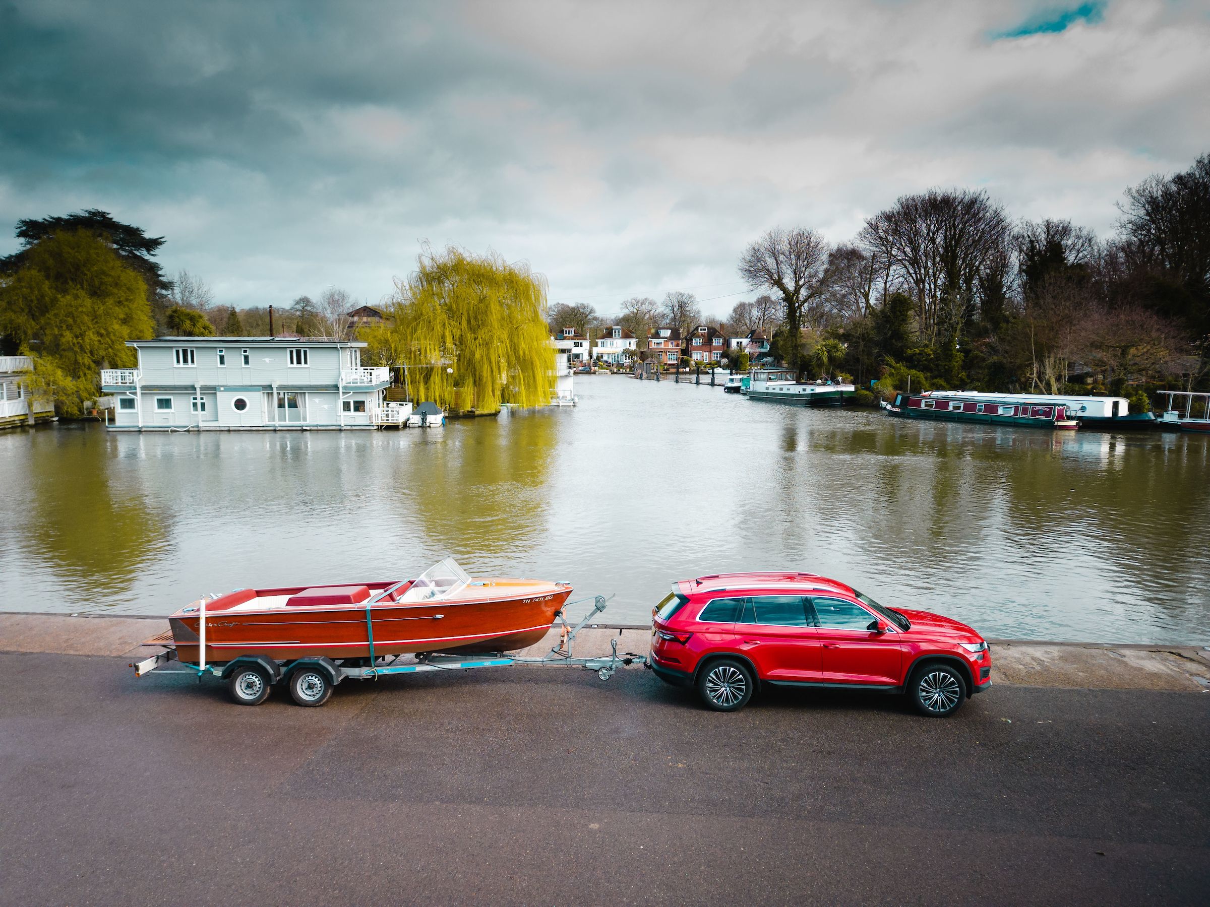 red car towing boat
