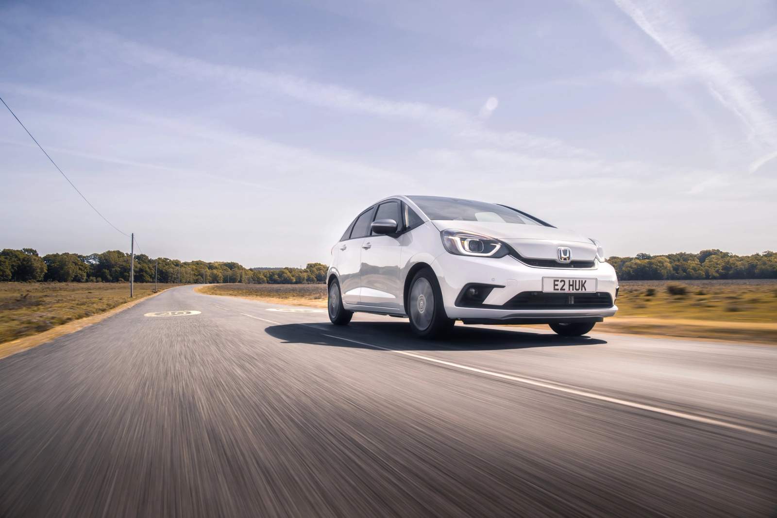 white car on road 
