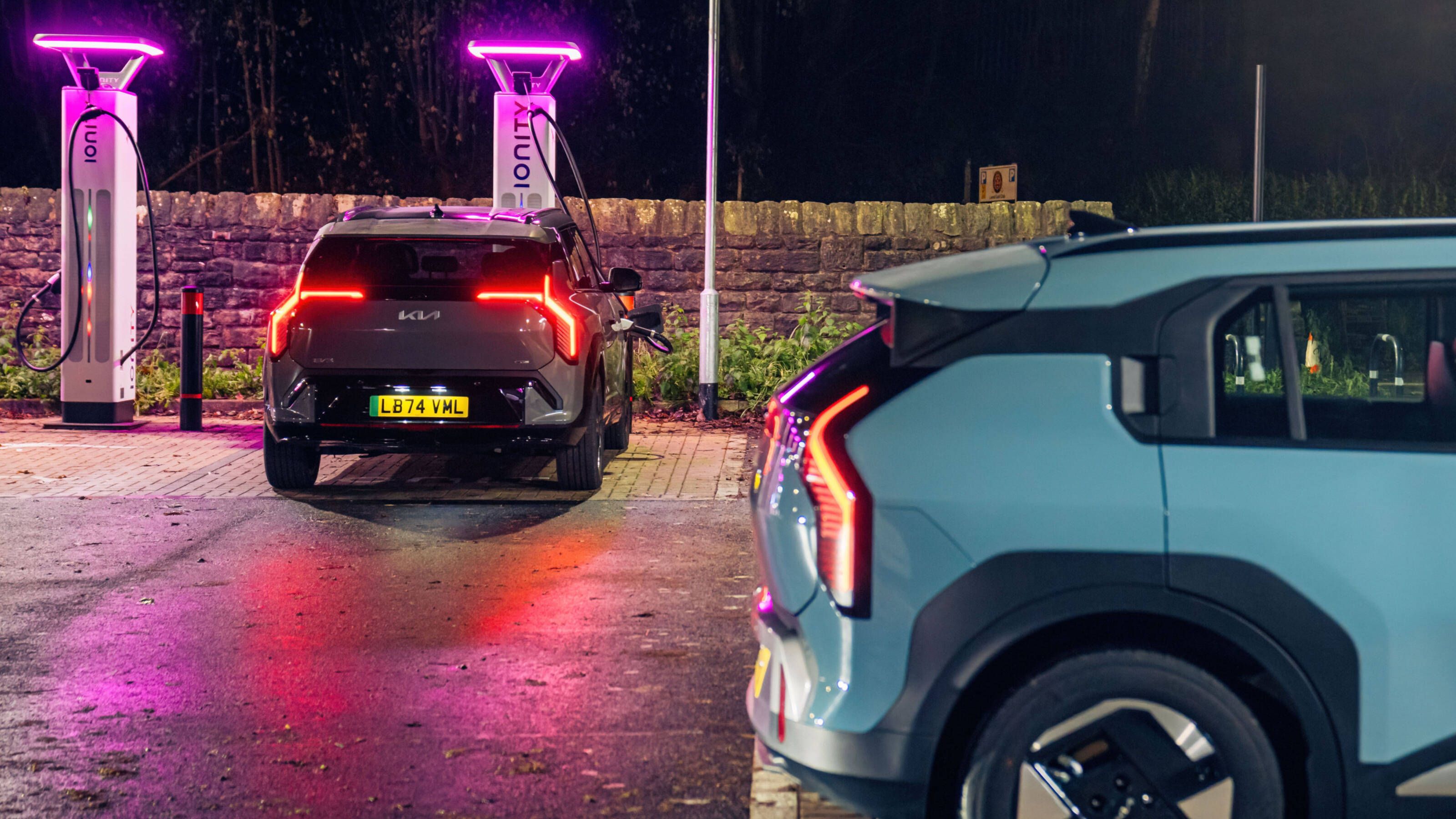 A blue and grey Kia EV3 rapid charging at an Ionity charging station at night