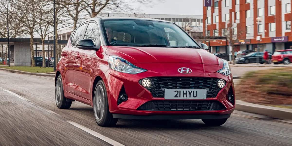 man driving red car