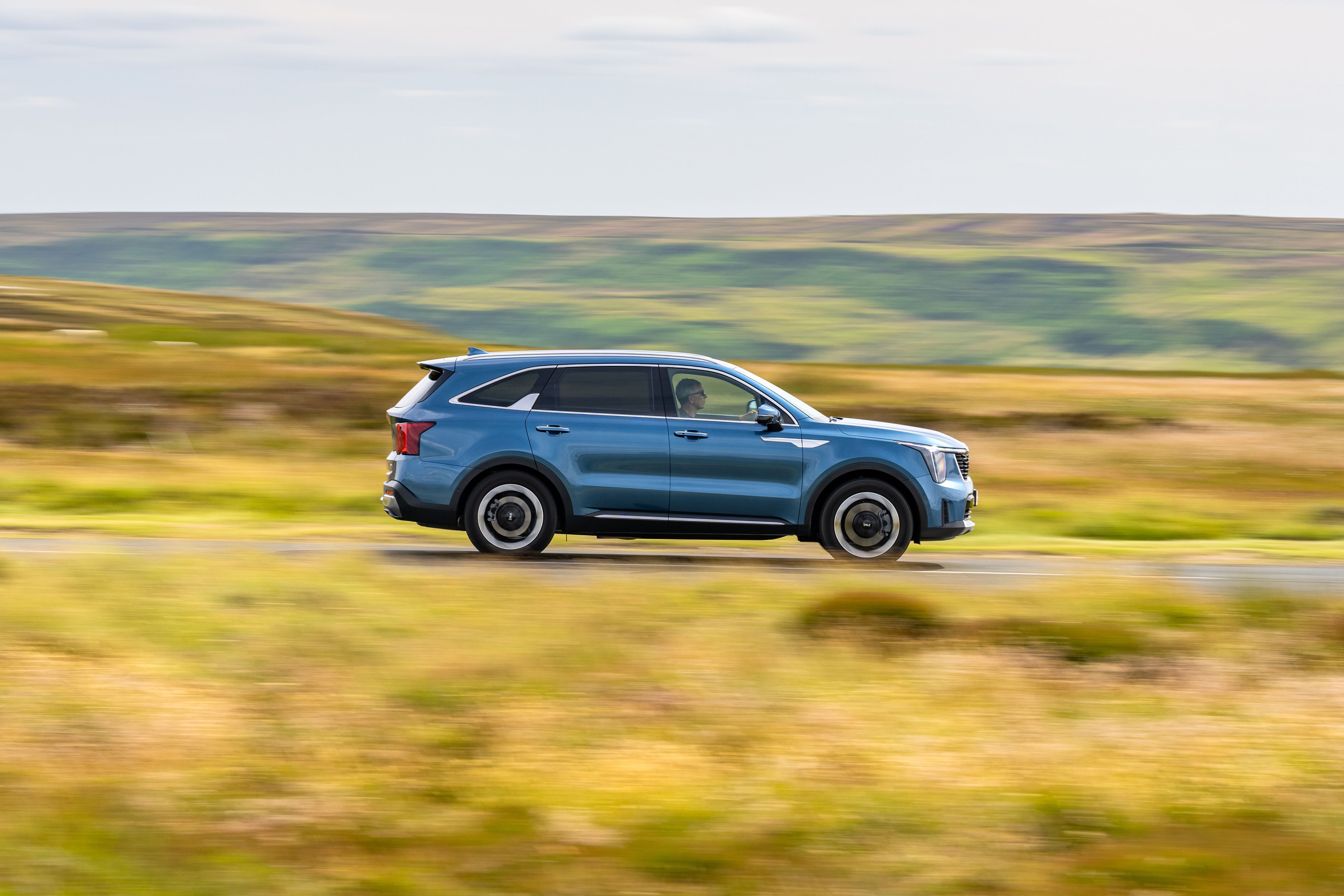 Blue Kia Sorento driving