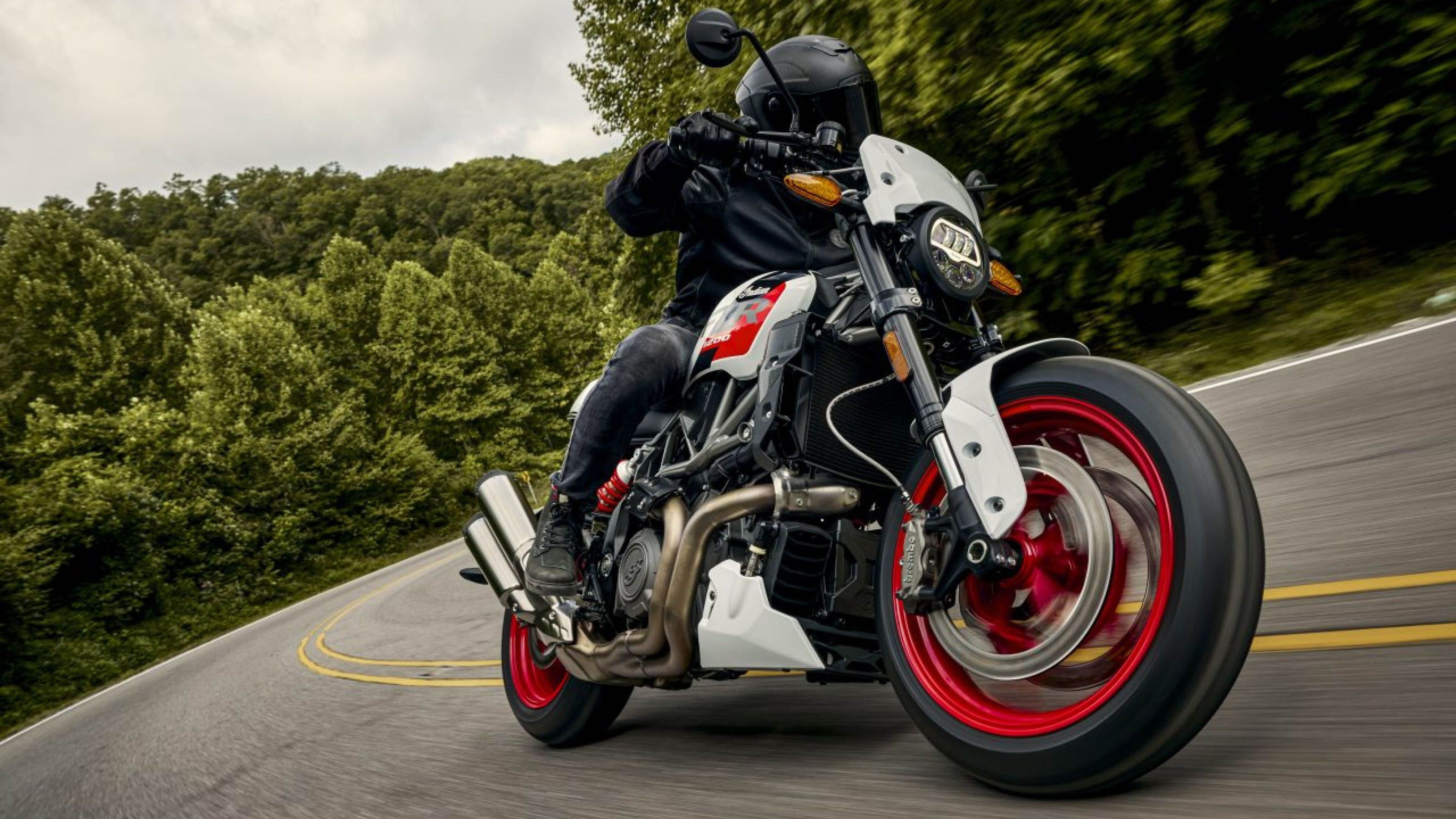 Rider steering an Indian motorbike around a corner