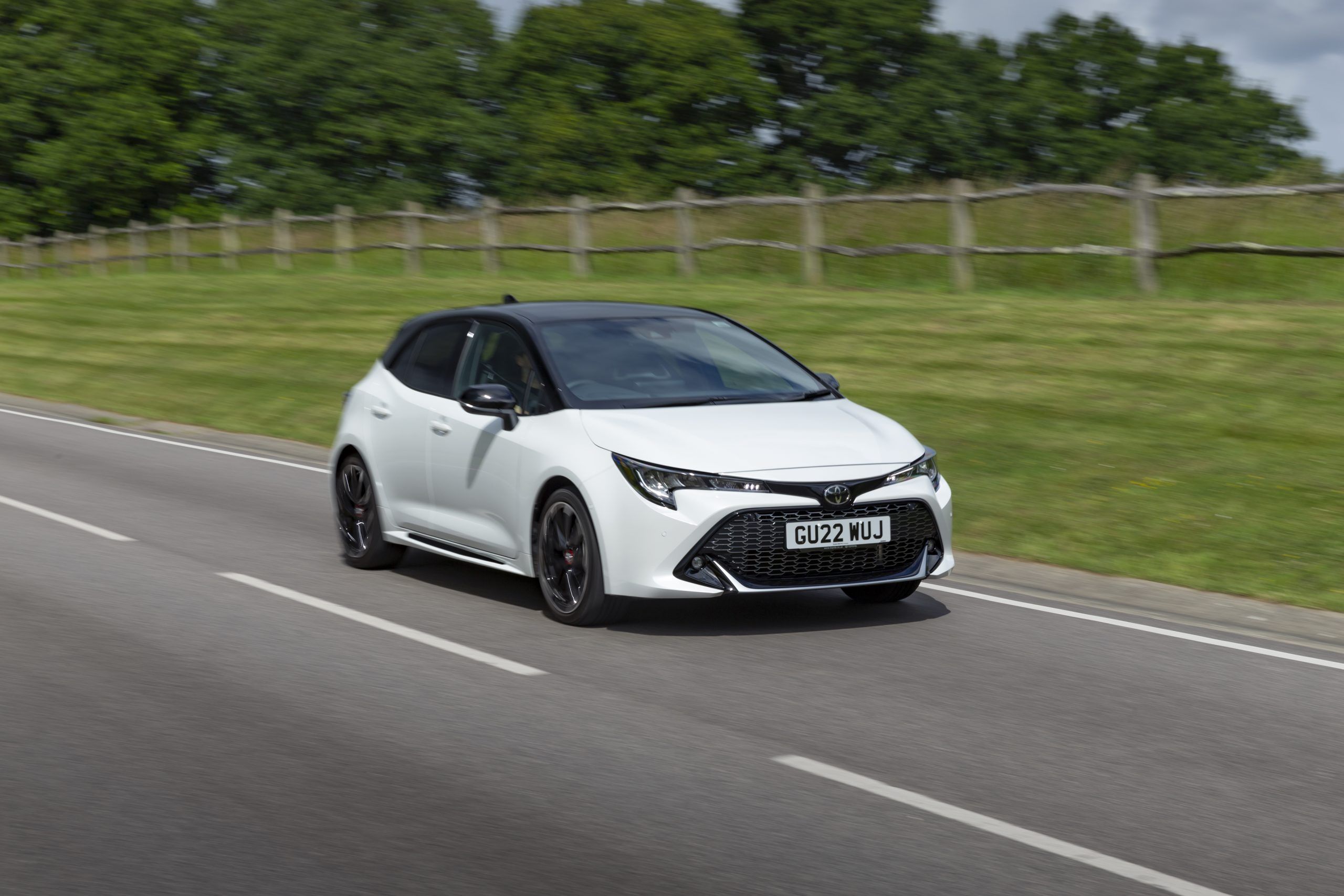 White Toyota Corolla driving