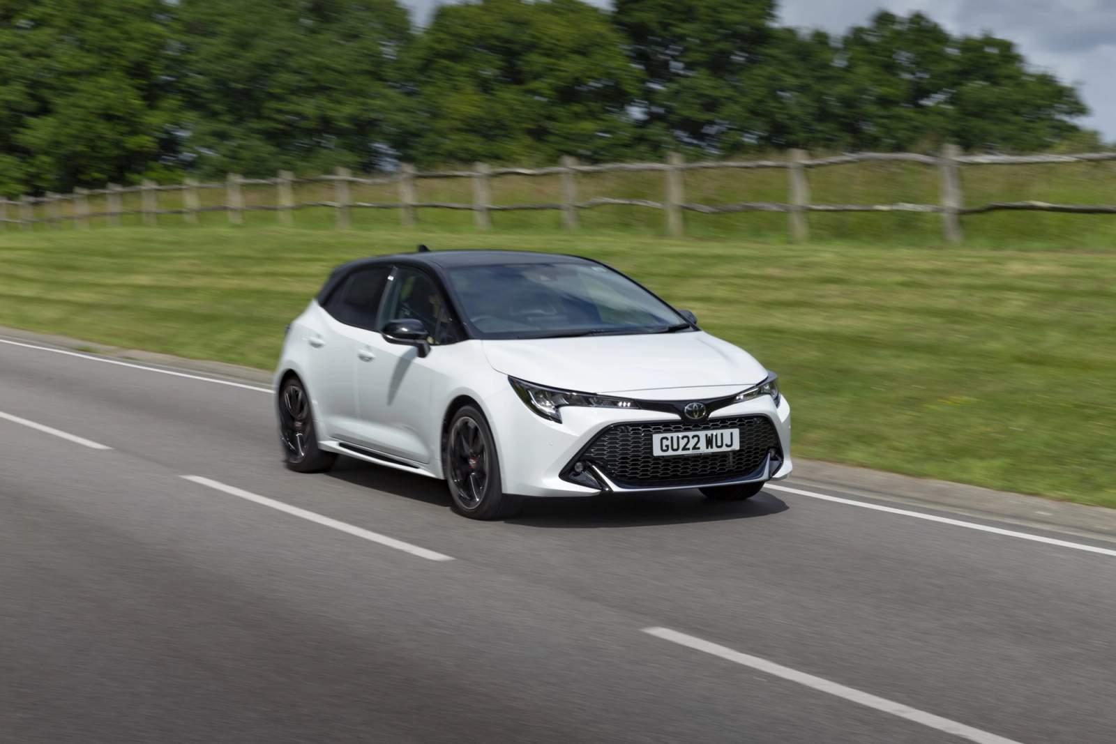 White Toyota Corolla driving
