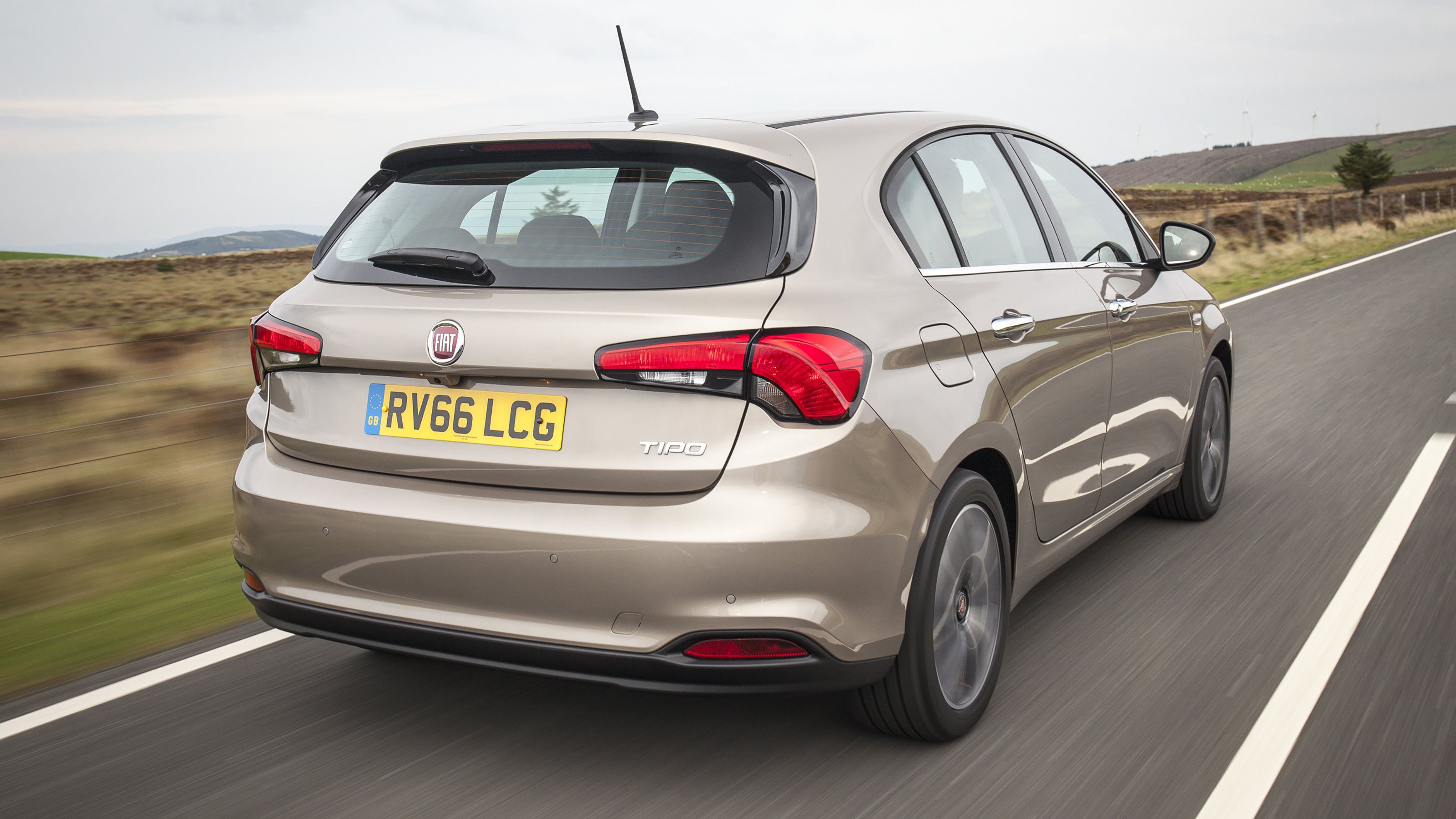 Beige Fiat Tipo rear driving