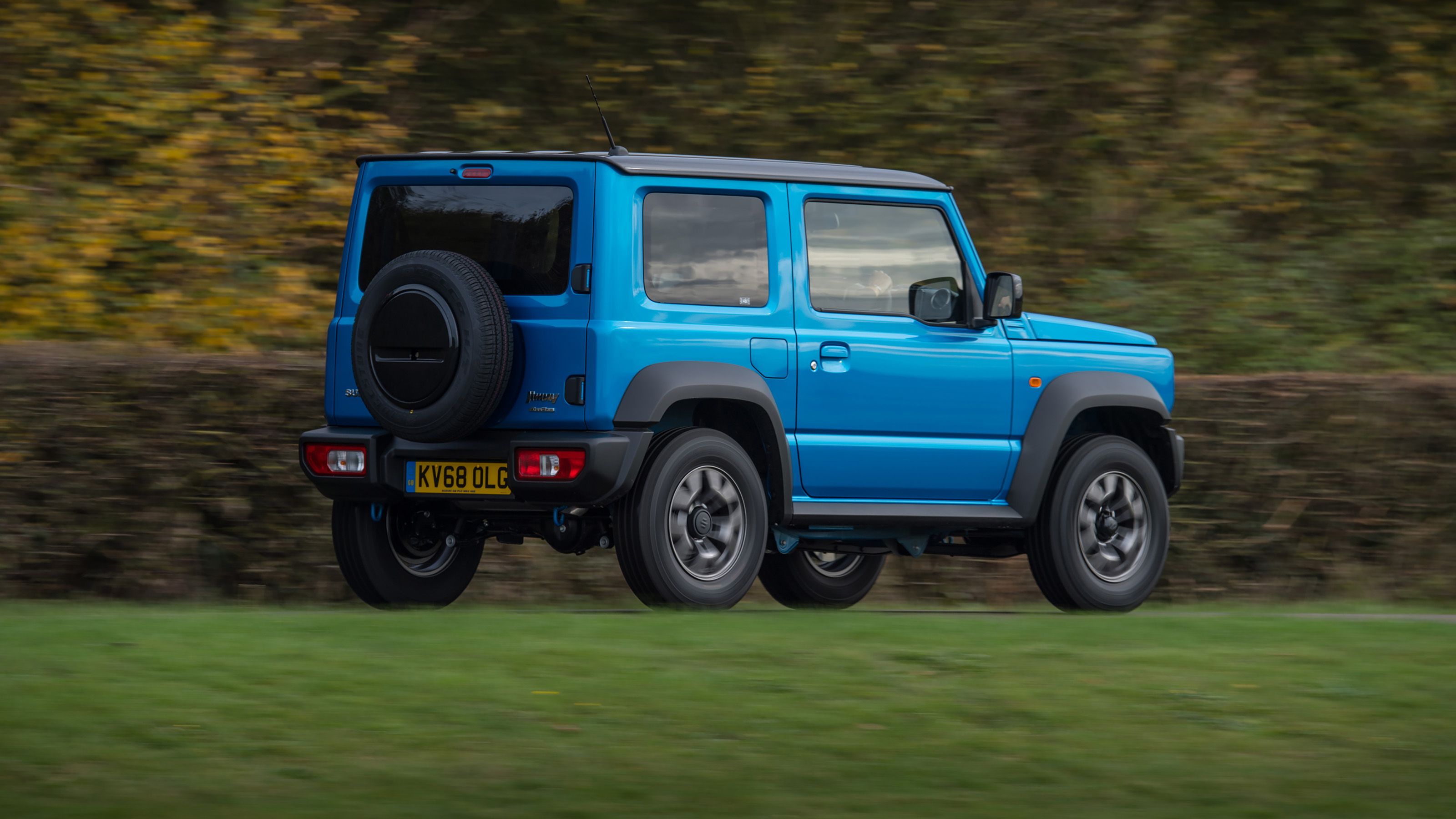 Blue Suzuki Jimny rear driving