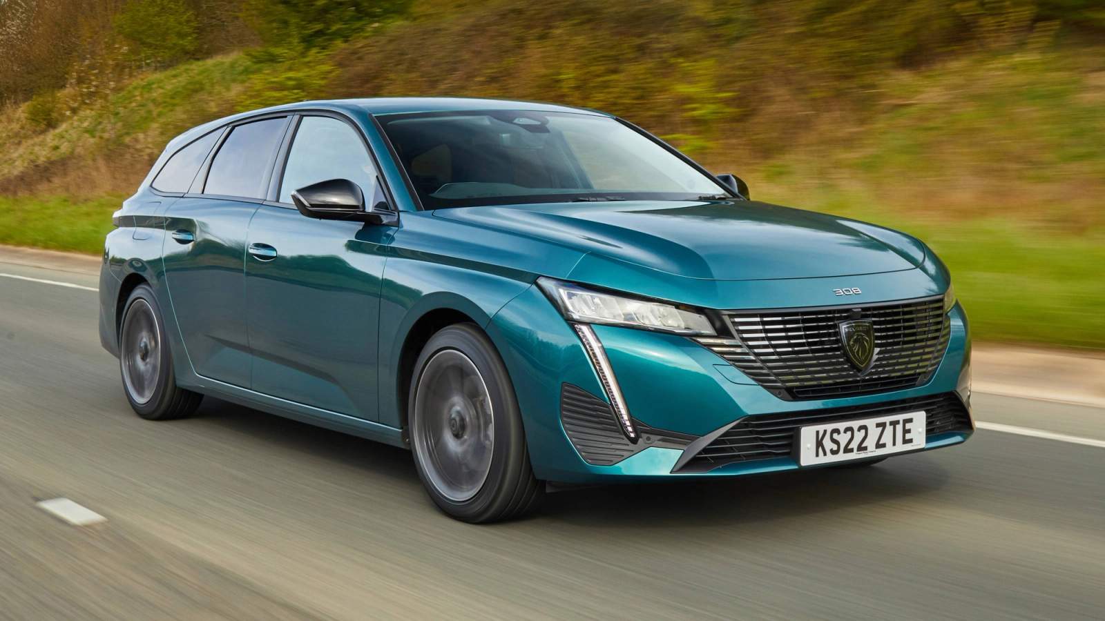 Turquoise Peugeot 308 SW driving