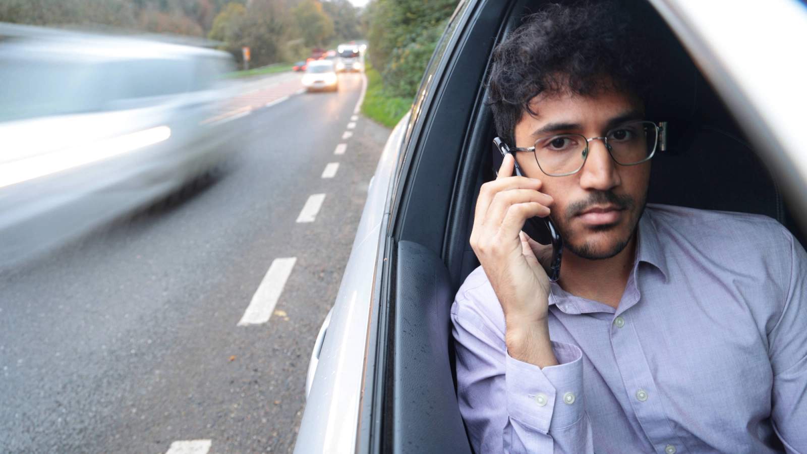 Man calling insurance company from his phone