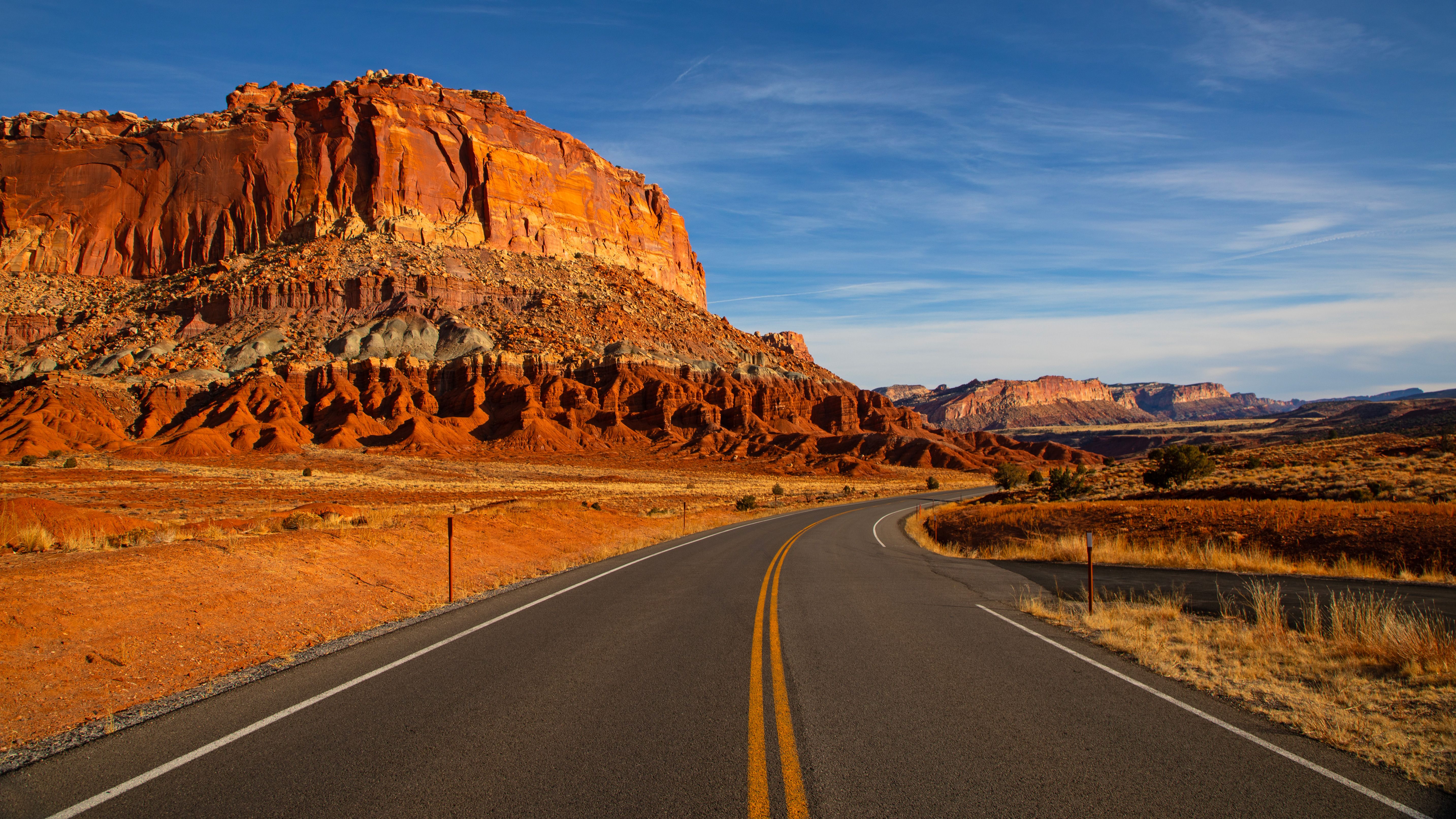 American road with red rock formations