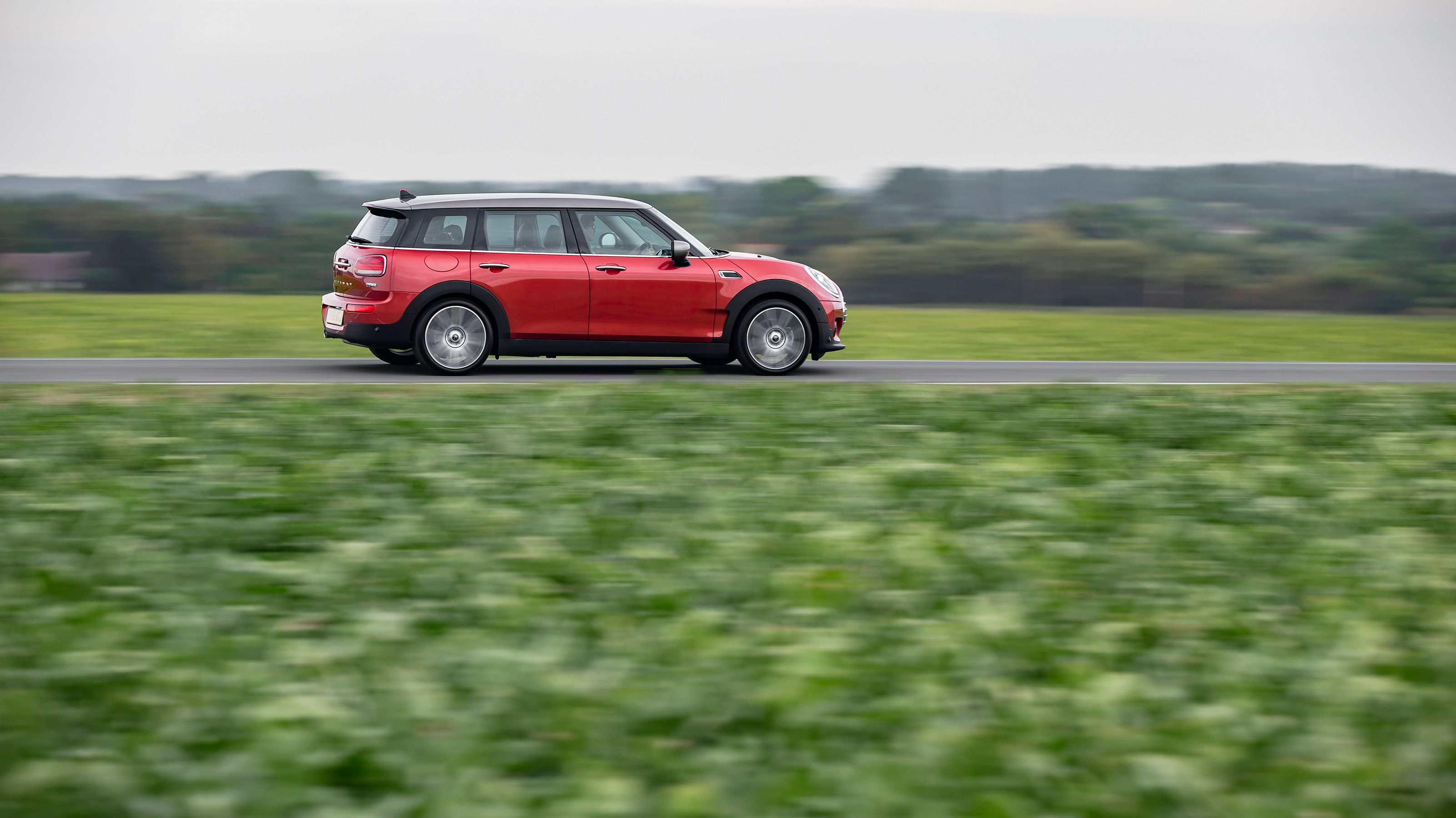 Red Mini Clubman side driving
