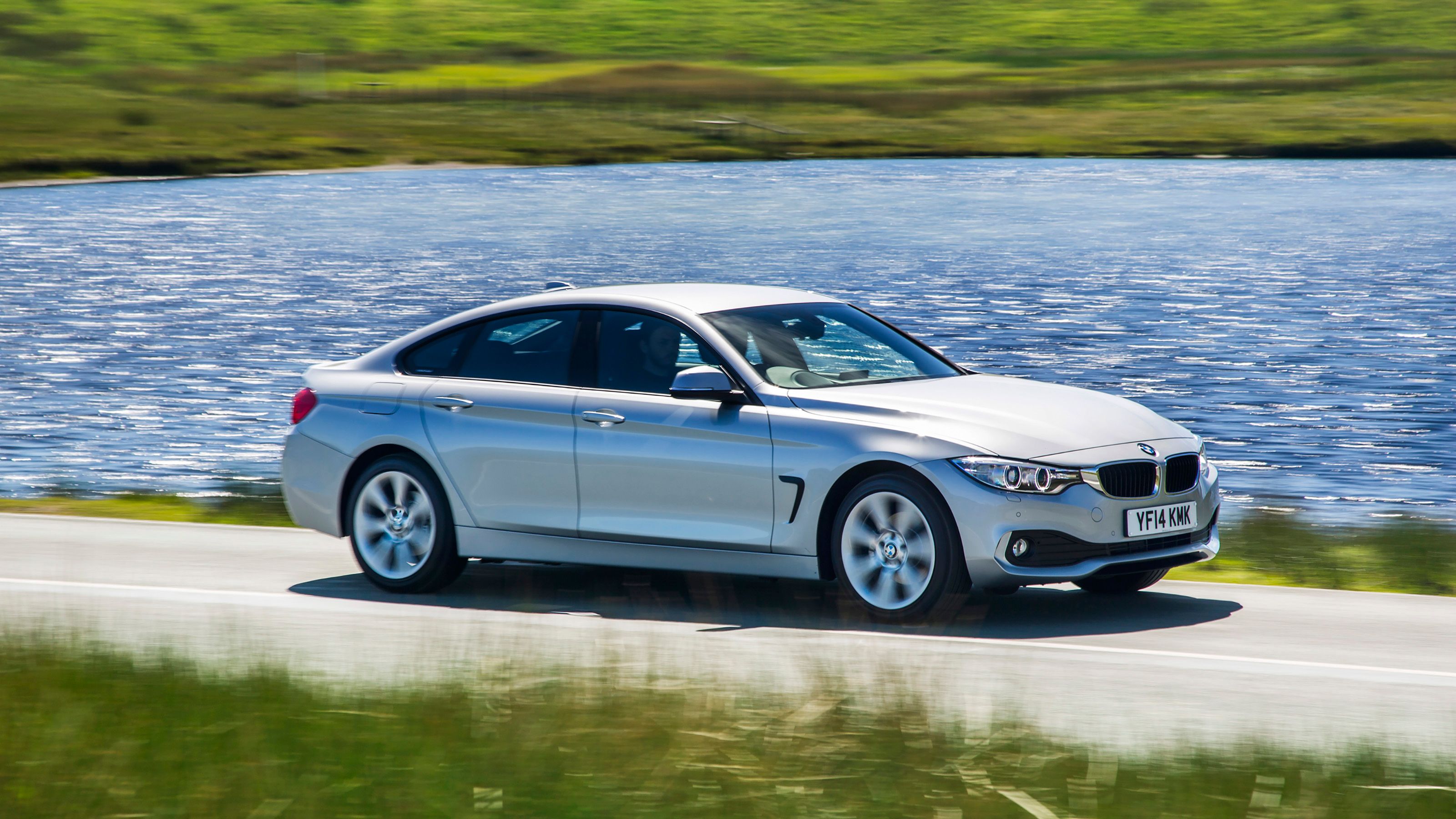 Silver BMW 4 Series Gran Coupe side driving