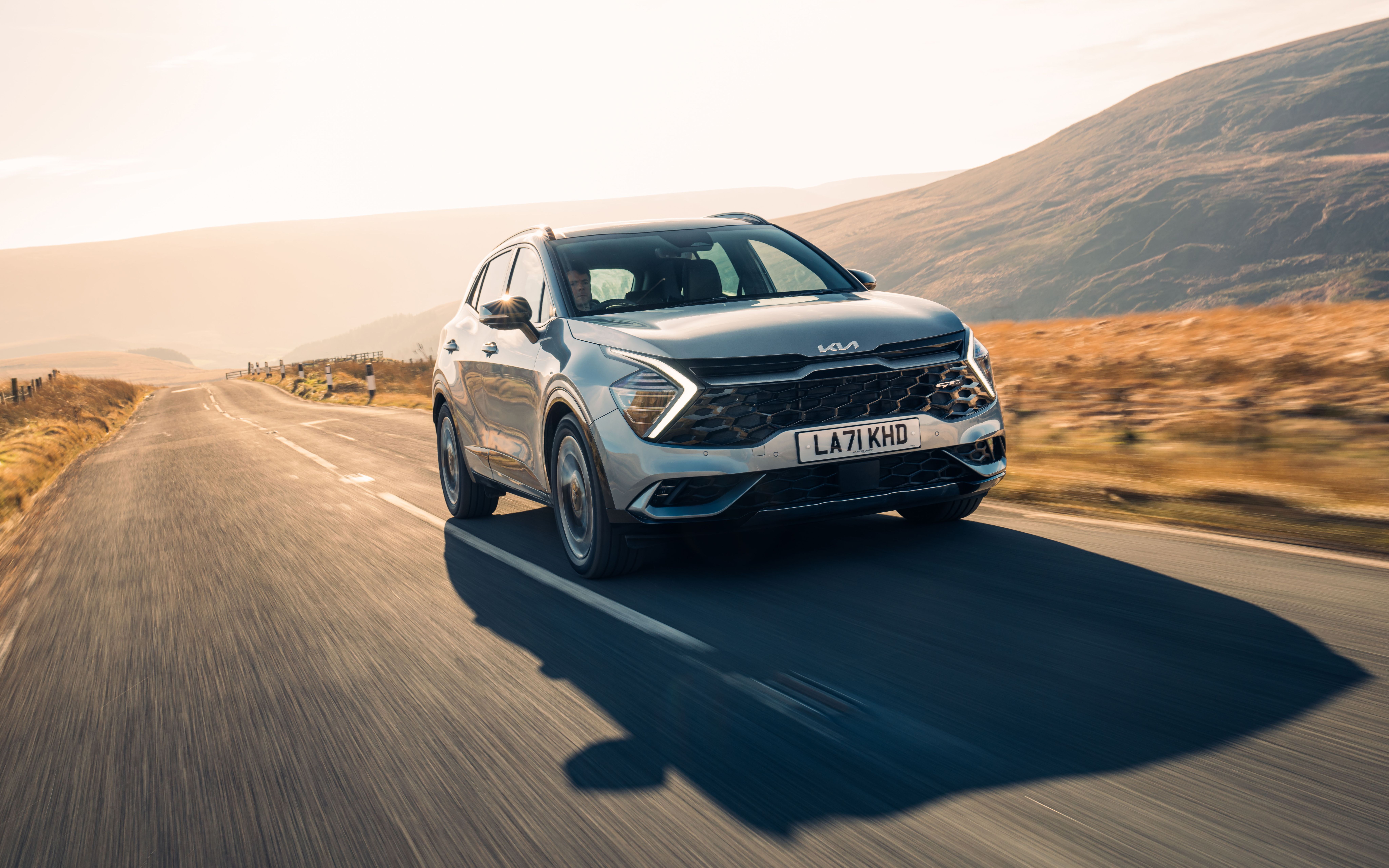 Silver Kia Sportage driving