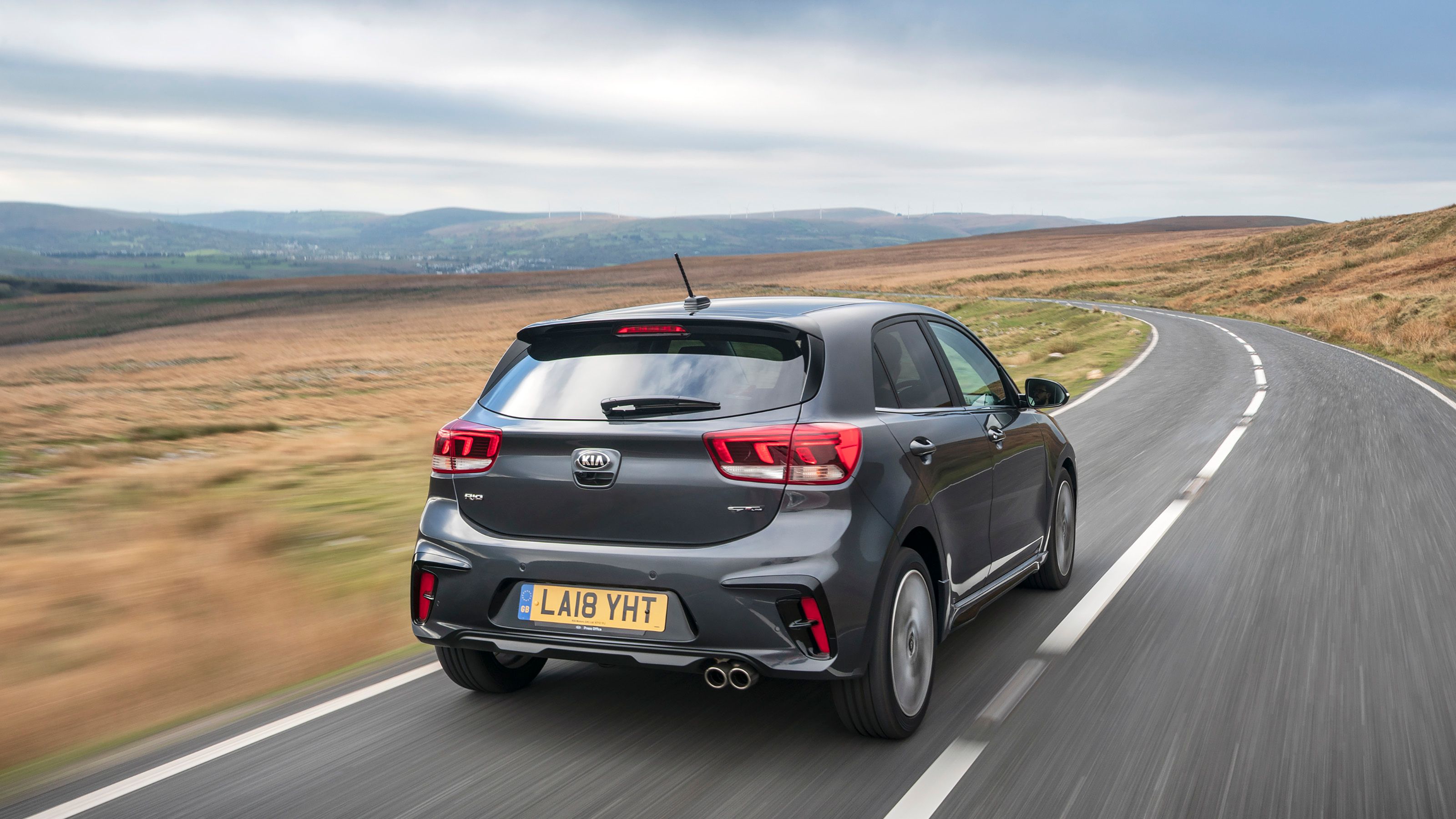 Grey Kia Rio rear driving