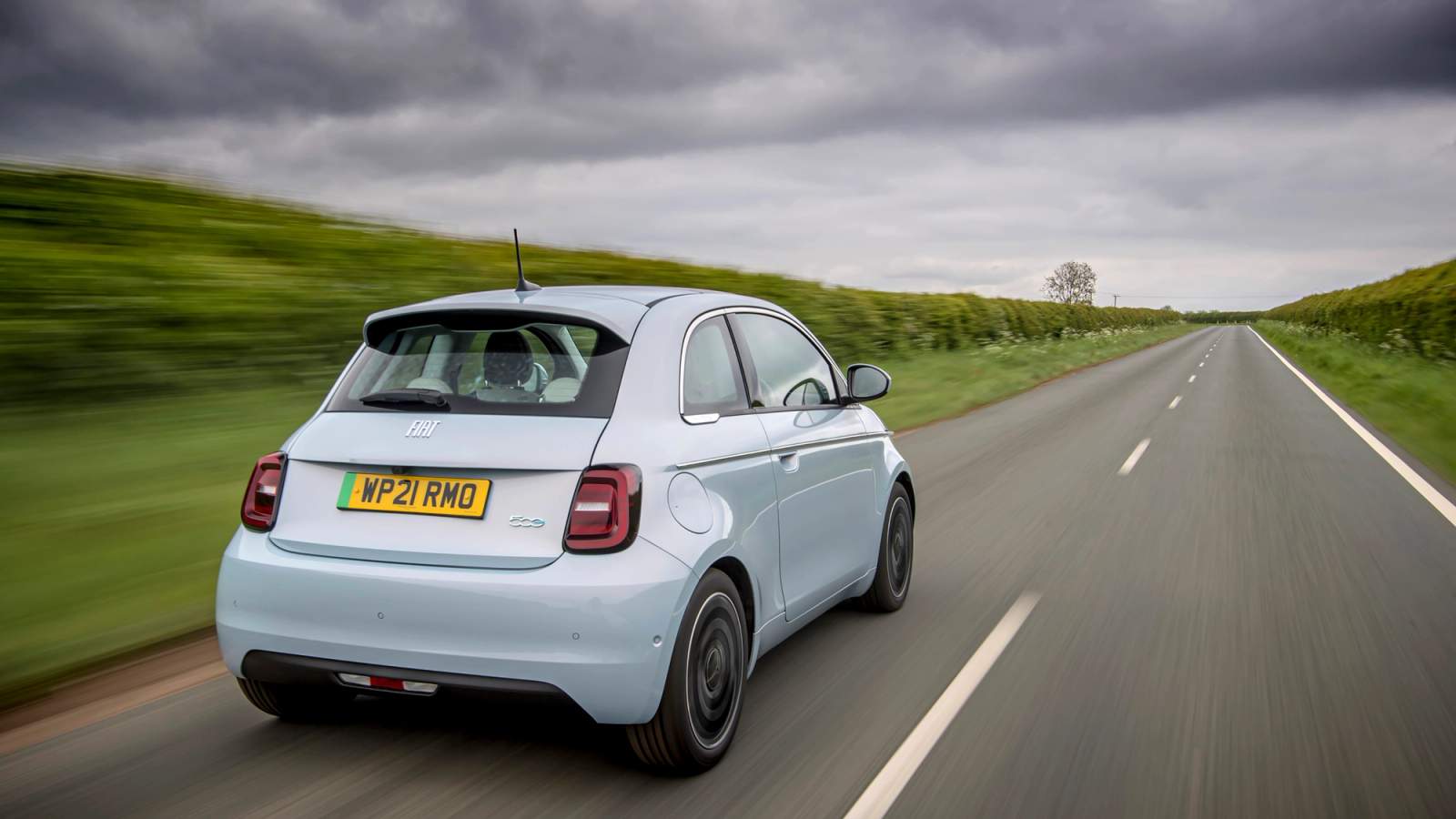 Blue Fiat 500e rear driving