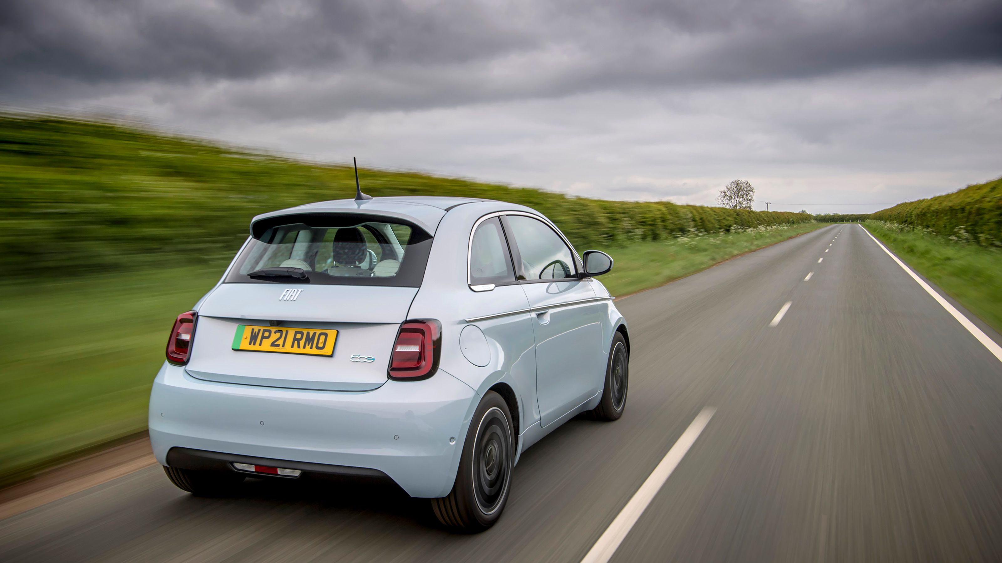 Blue Fiat 500e rear driving