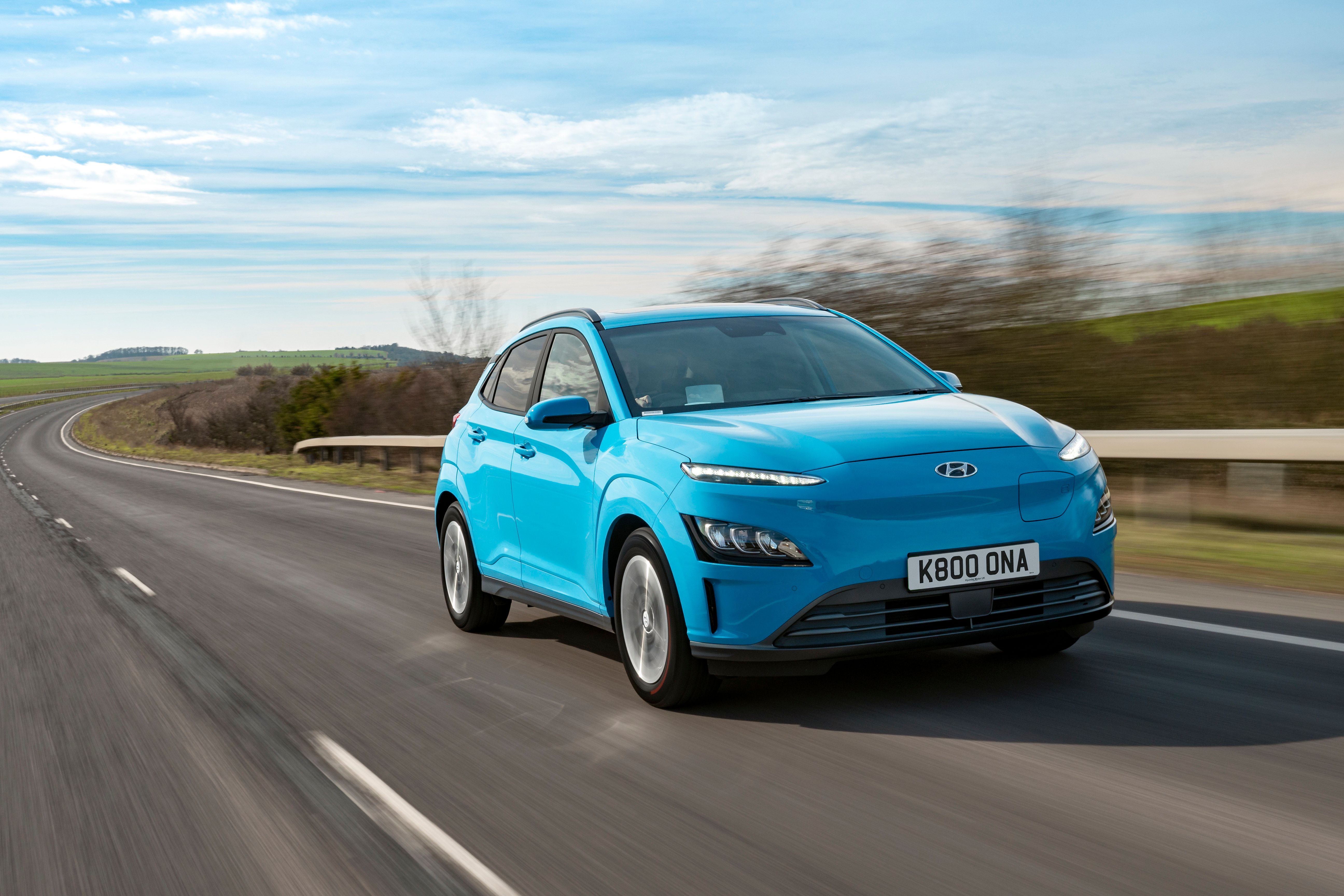 Blue Hyundai Kona Electric driving