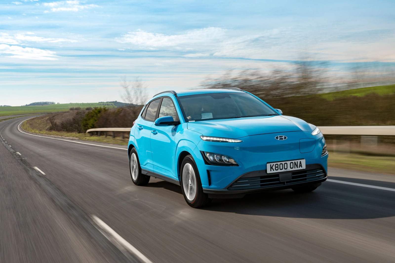 Blue Hyundai Kona Electric driving