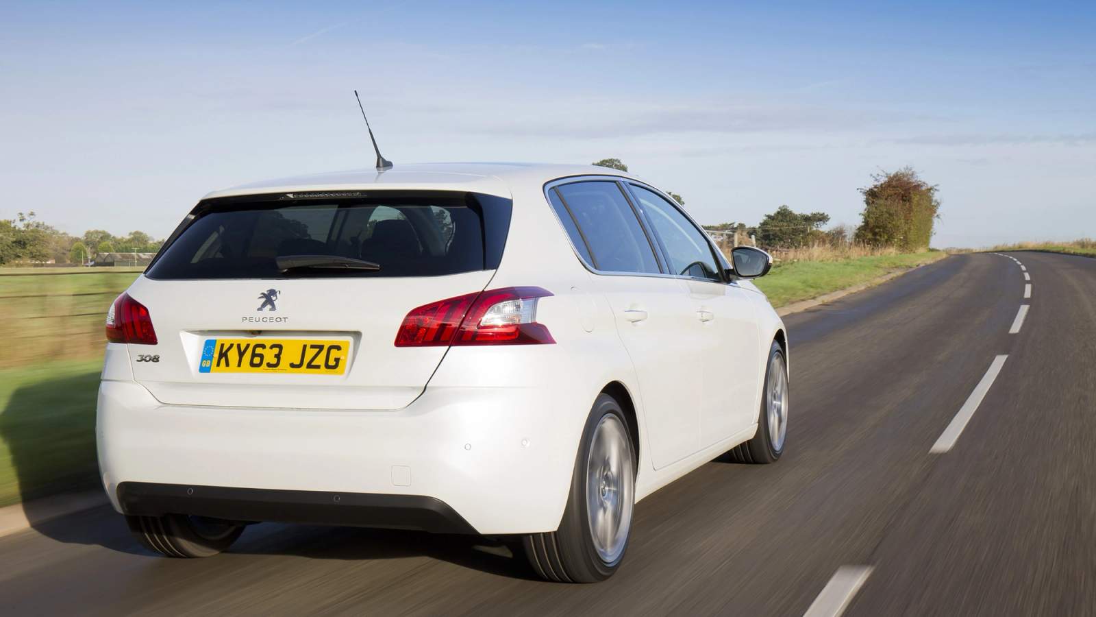 White Peugeot 308 rear driving