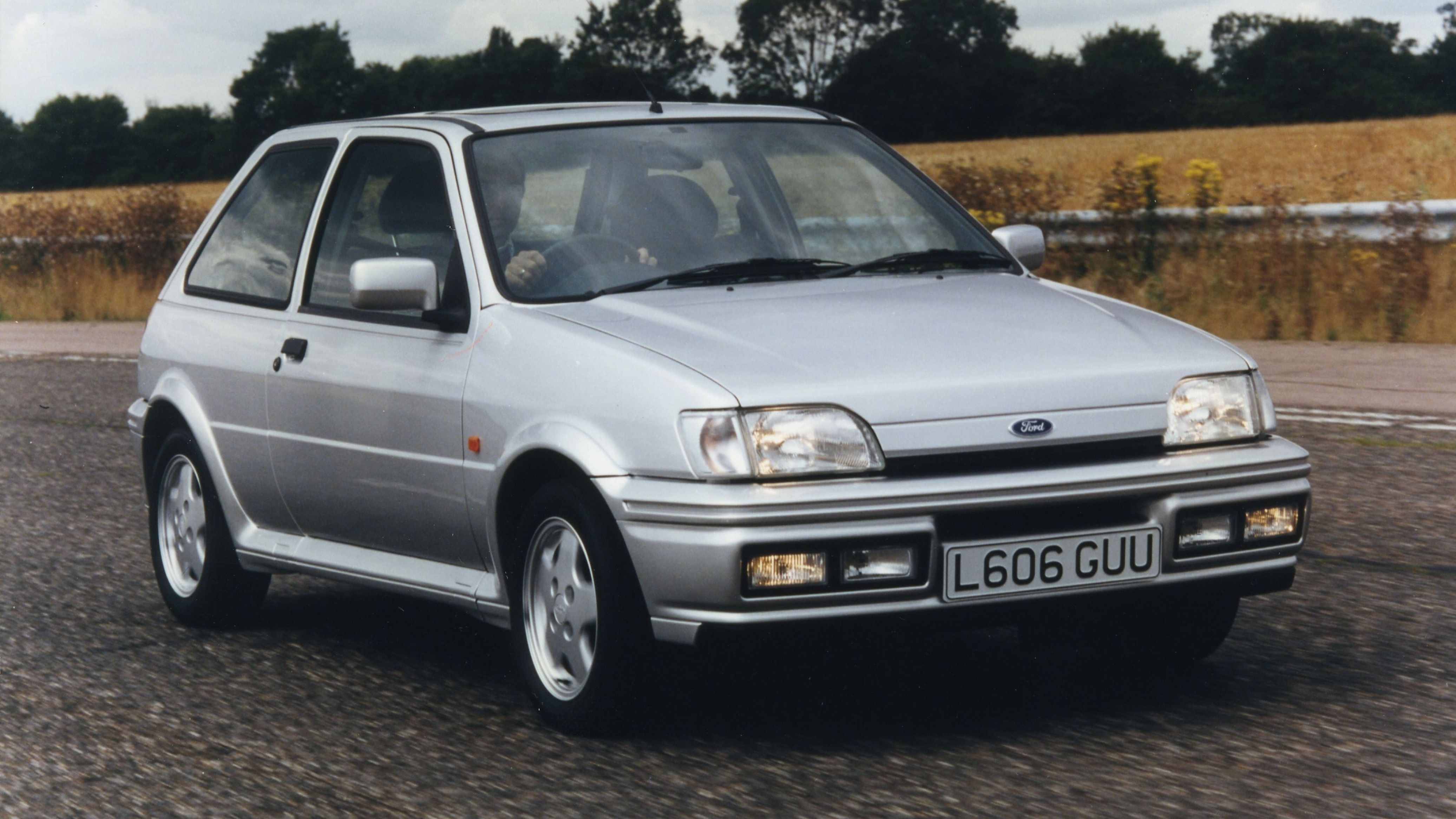 Silver Ford Fiesta XR2i driving on road