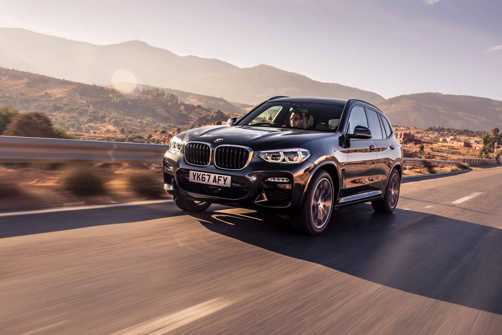 Black BMW X3 driving