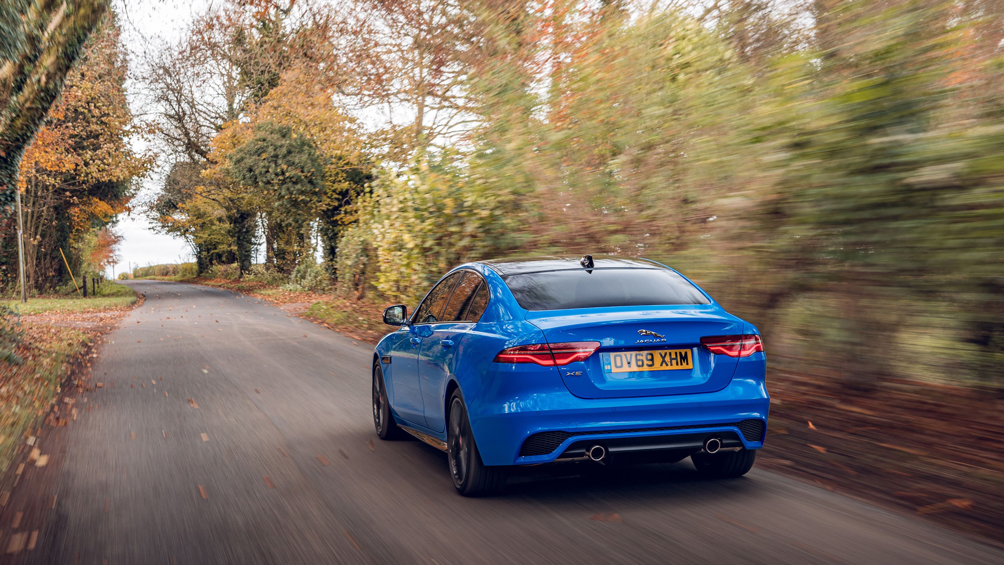Blue Jaguar XE rear driving