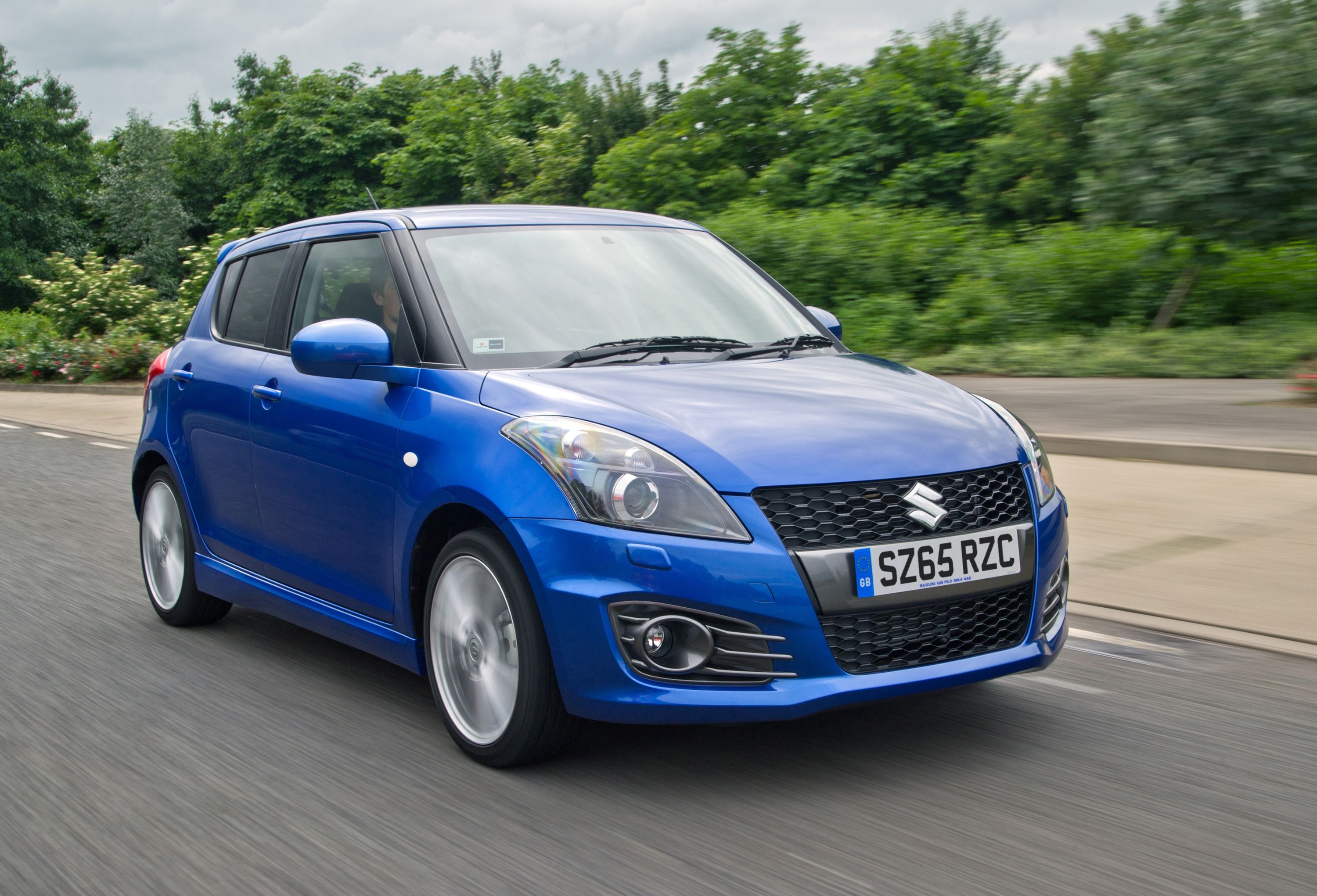 Blue Suzuki Swift Sport driving
