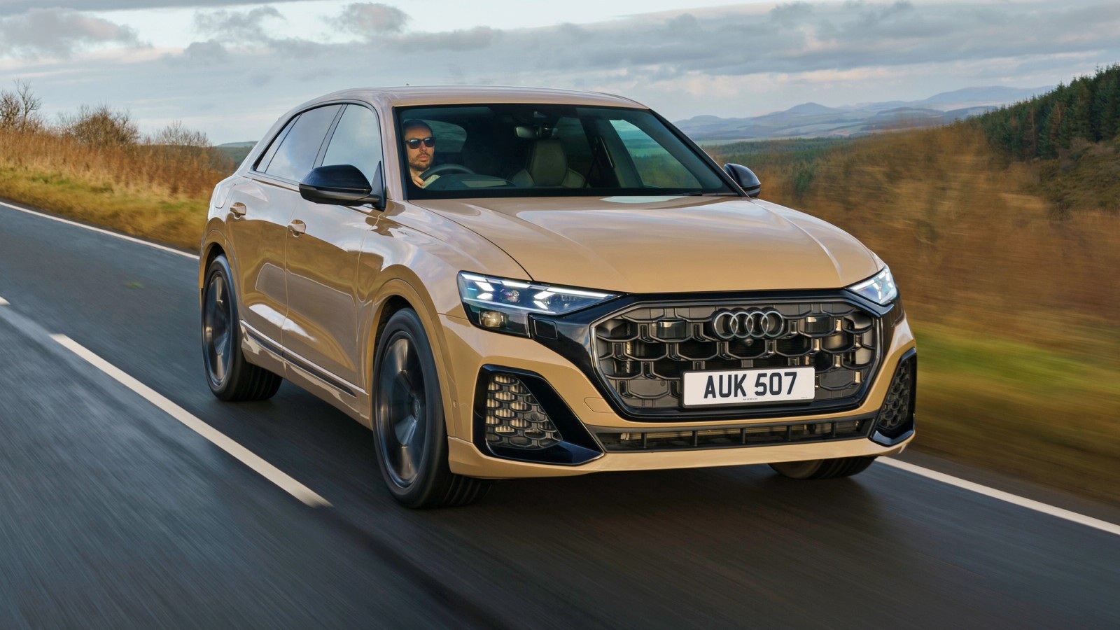 Beige Audi SQ8 front driving