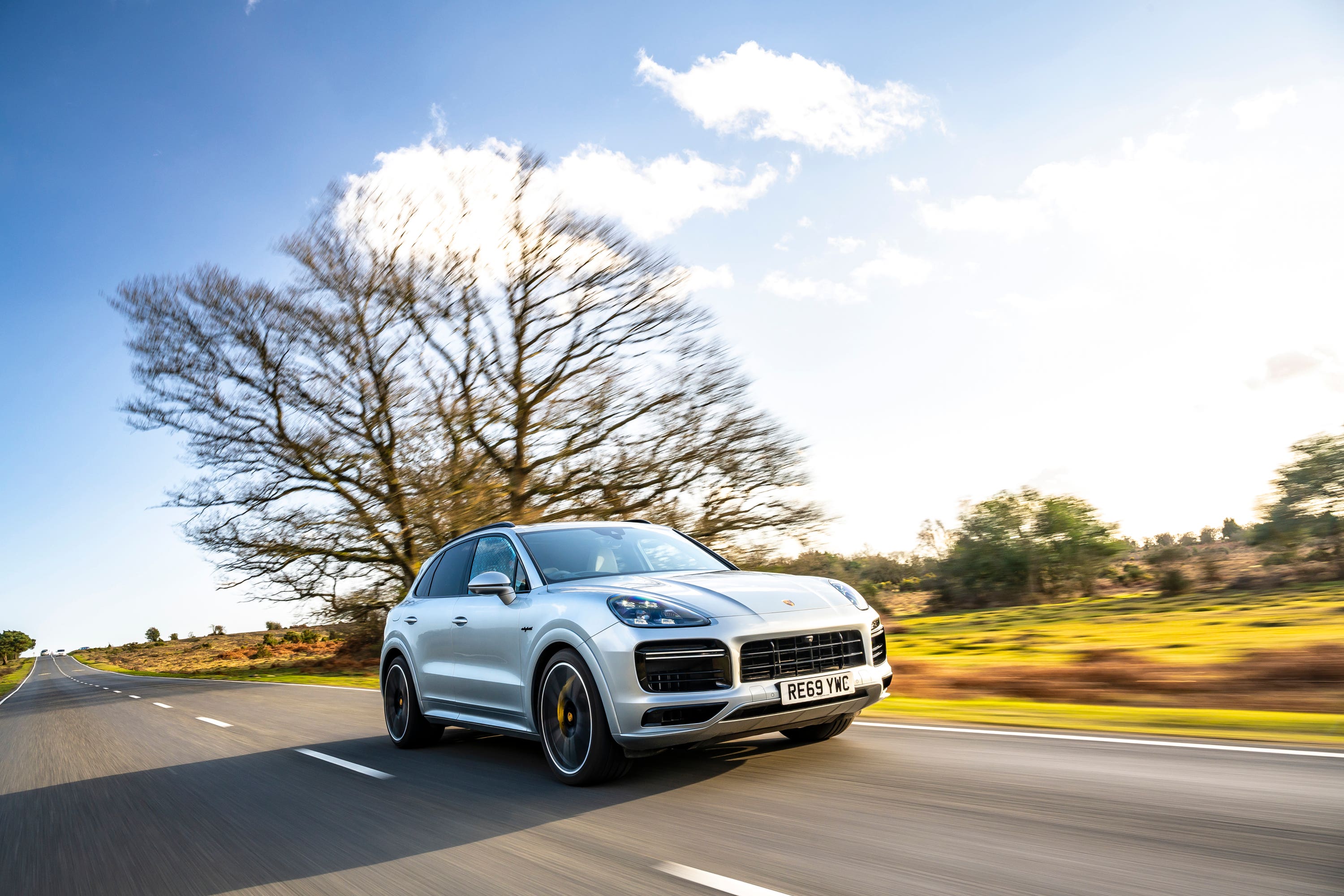 Silver Porsche Cayenne driving