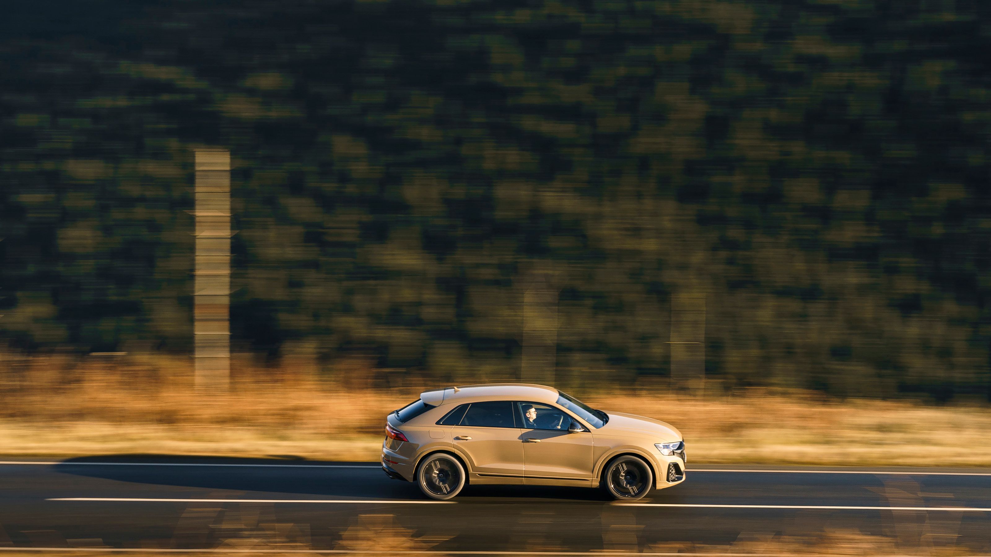 Beige Audi SQ8 side driving