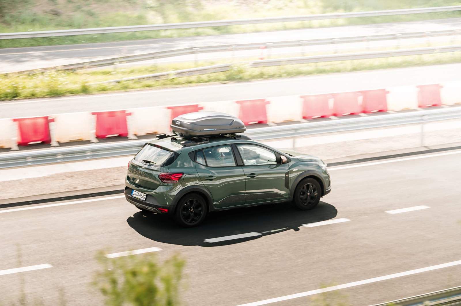 green car on the road
