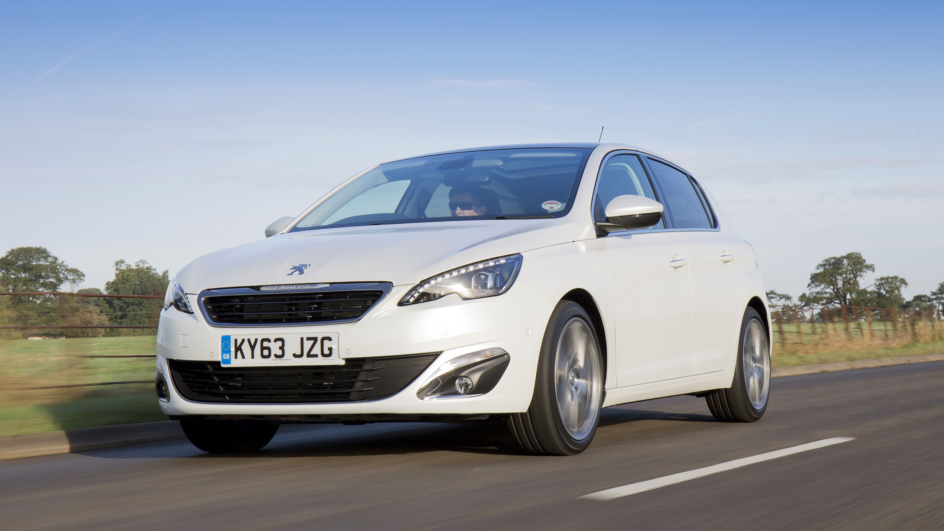 White Peugeot 308 front driving