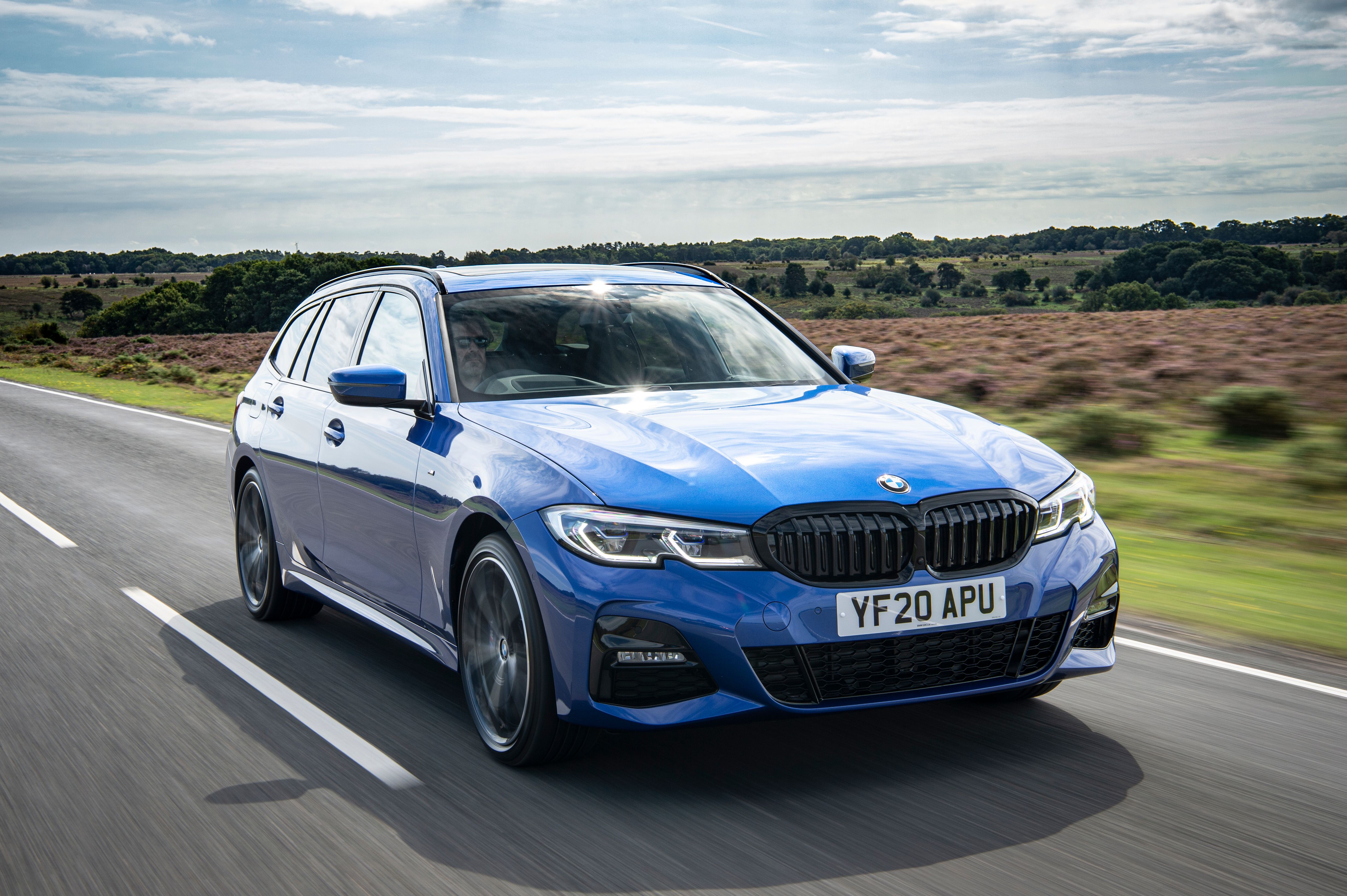 Blue BMW 3 Series Touring driving