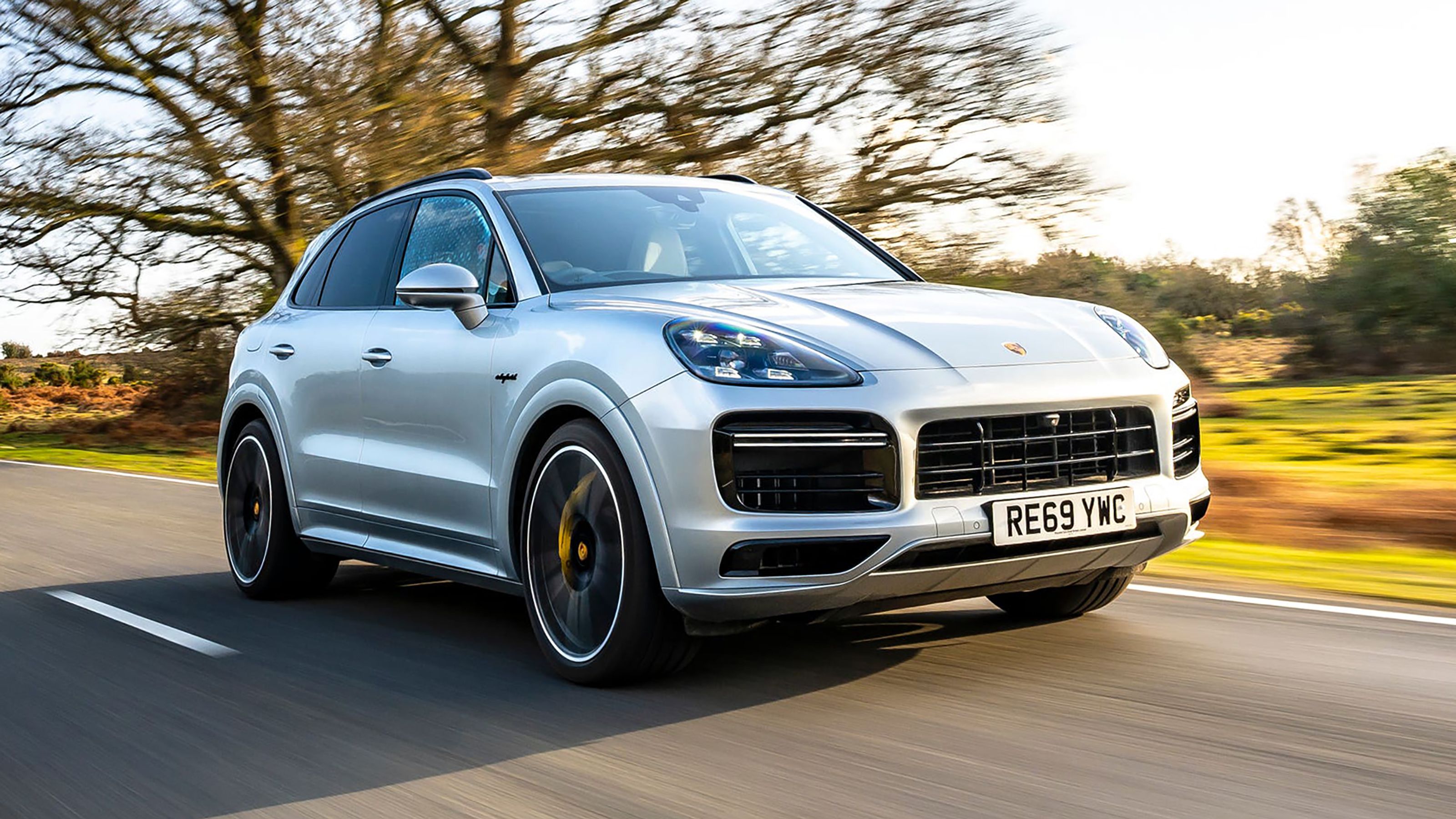 Silver Porsche Cayenne front driving