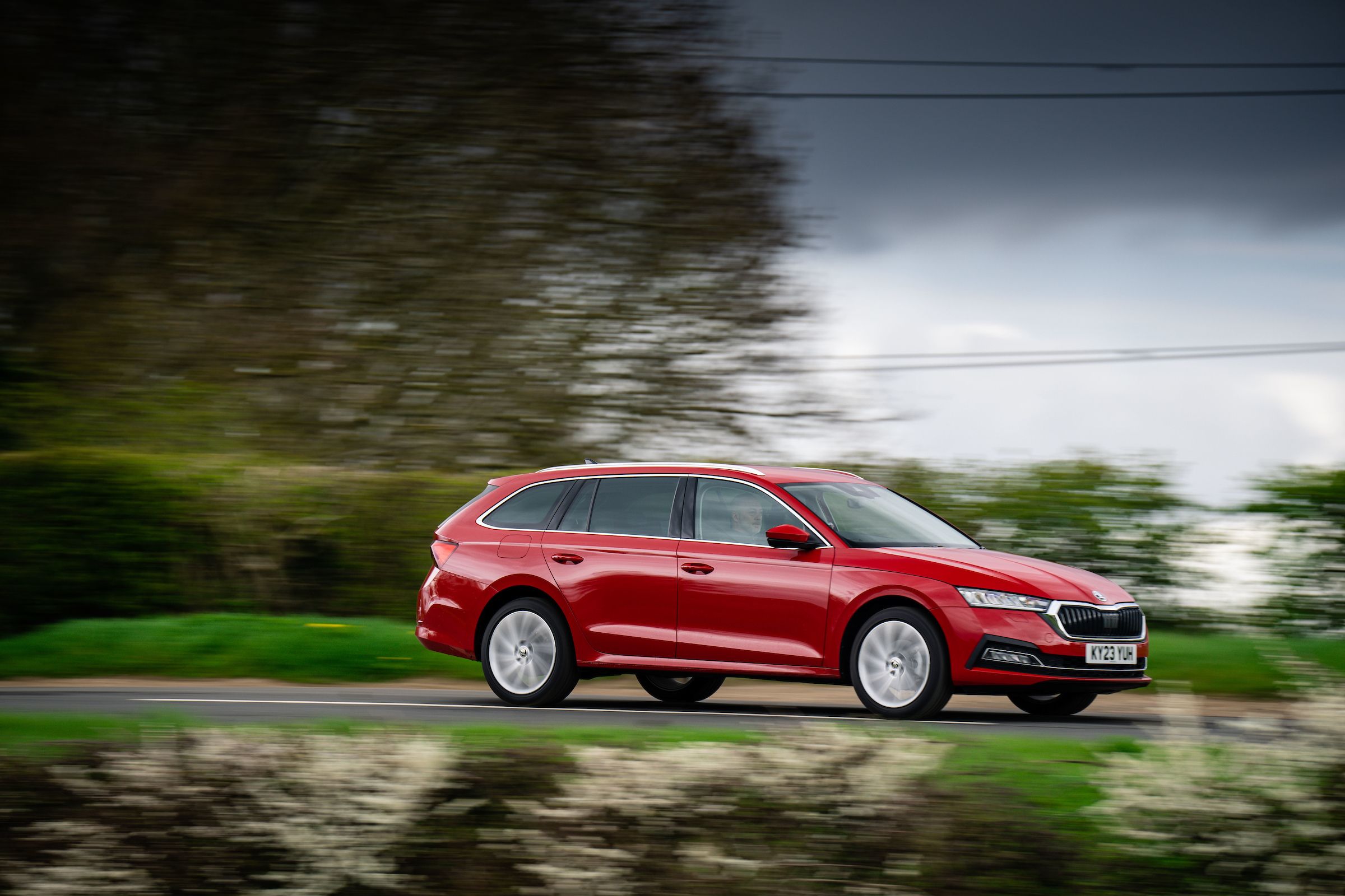 Red Skoda Octavia Estate dristate drivingving