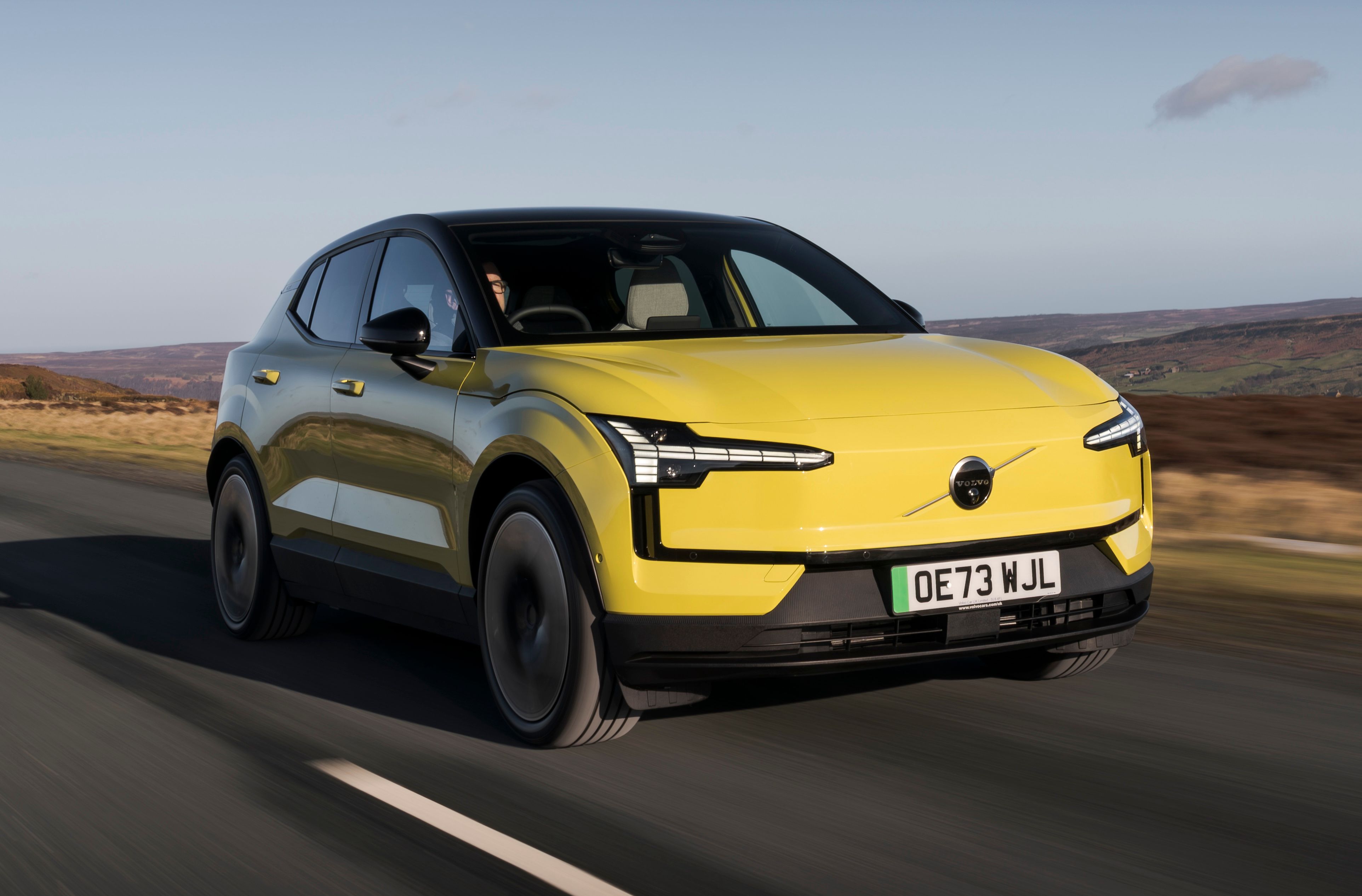 Yellow Volvo EX30 driving