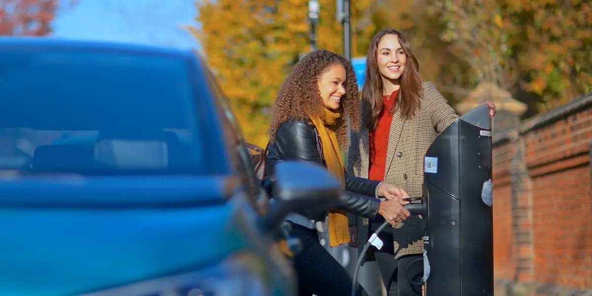 women charging electric car