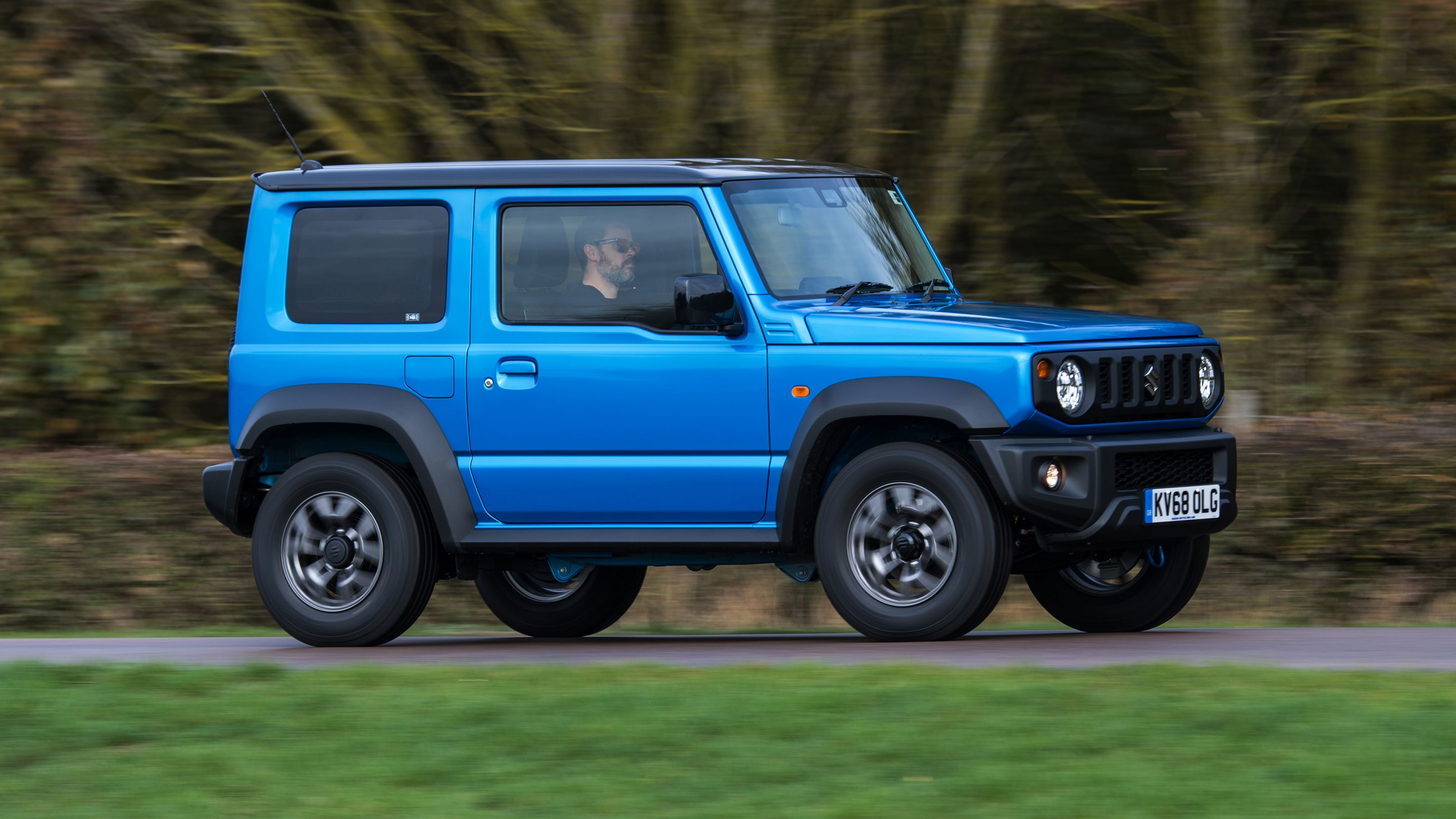 Blue Suzuki Jimny front driving
