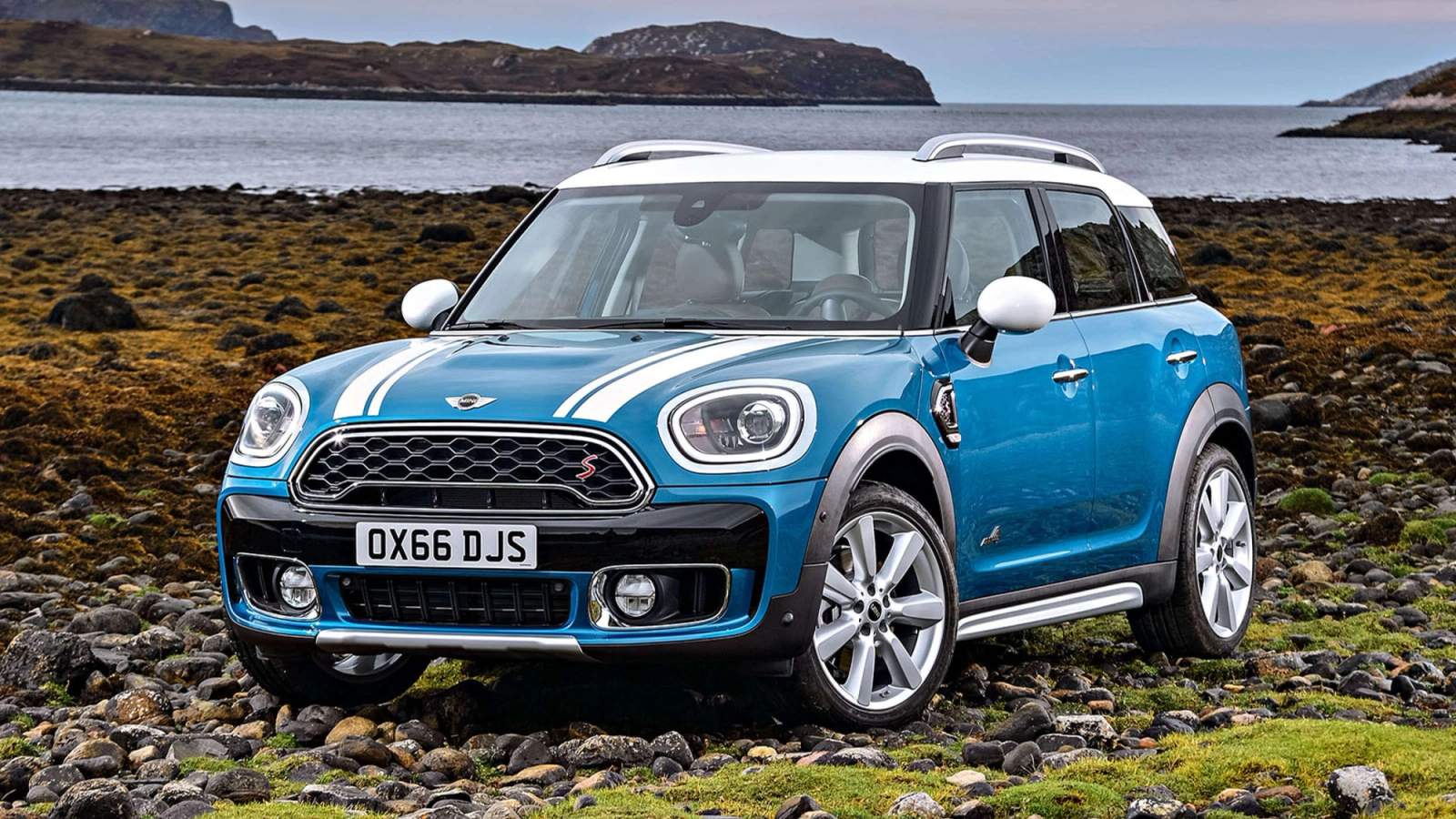 Blue Mini Countryman parked on rocky beach 