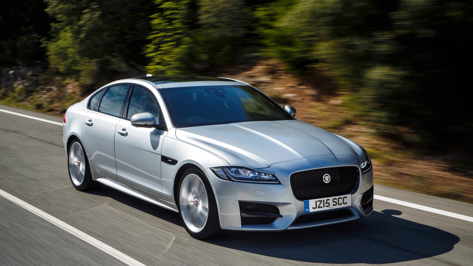 Silver Jaguar XF front driving