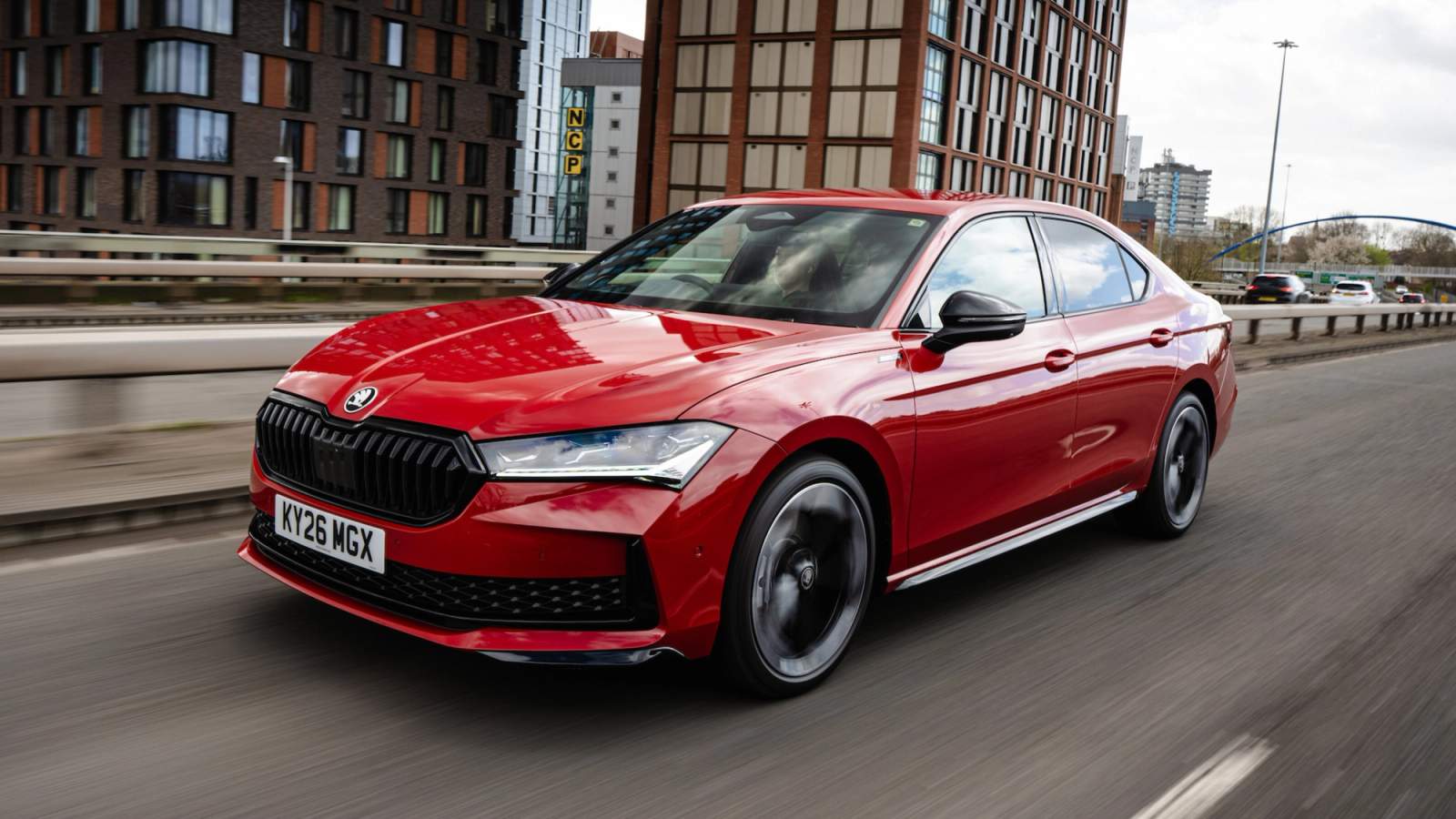 Red Skoda Superb driving