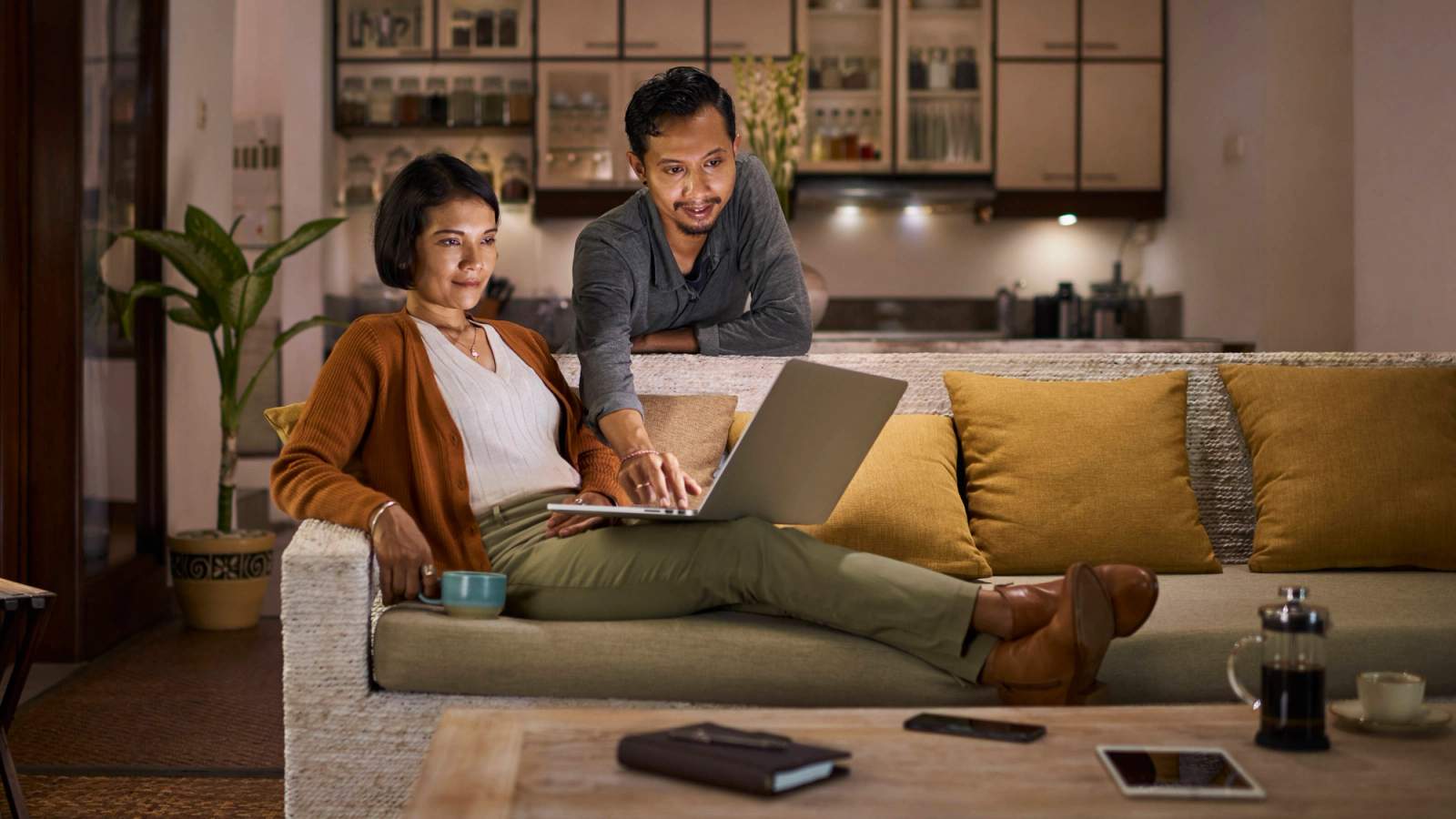 Couple buying GAP insurance on their sofa