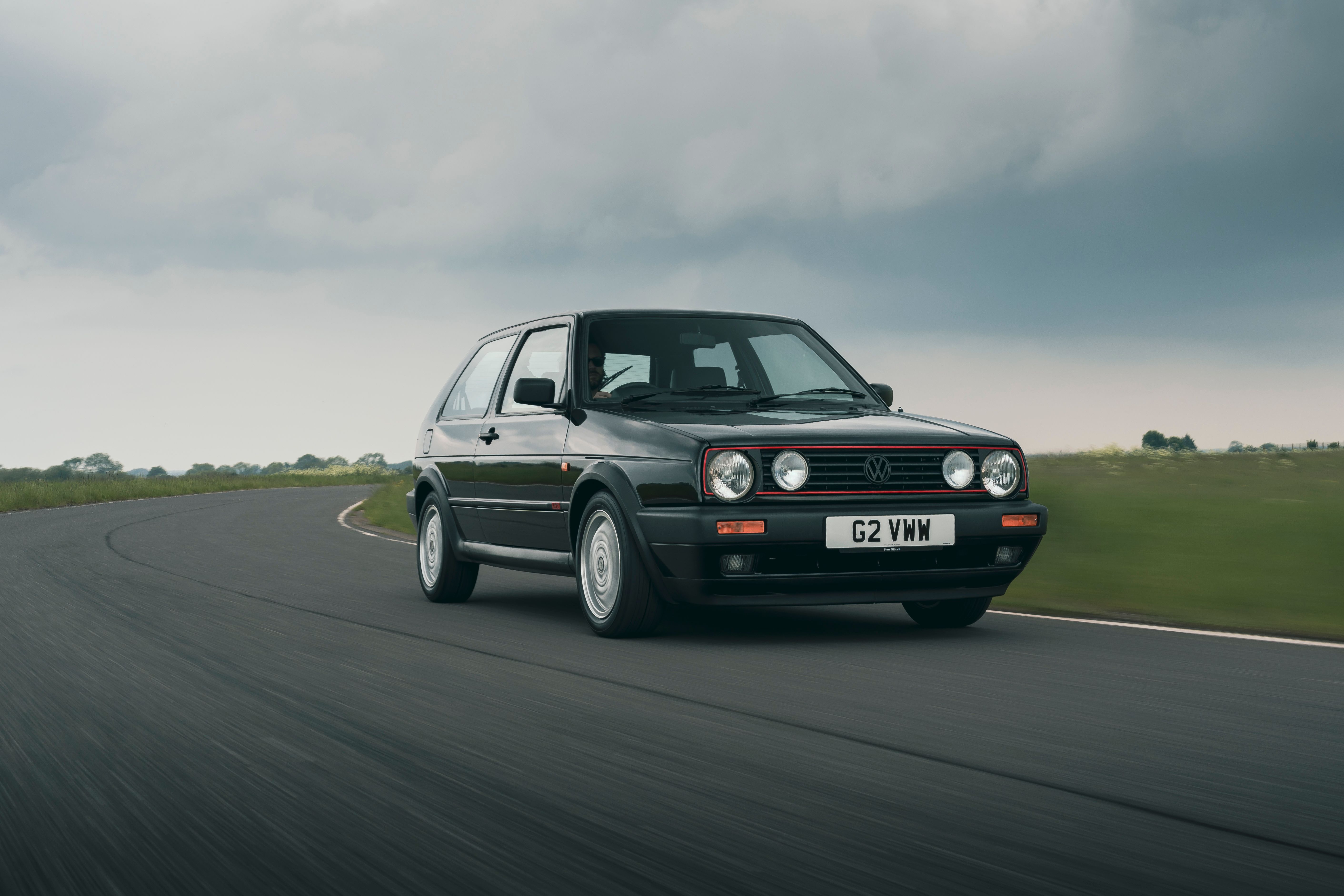 Black Volkswagen Golf GTI driving